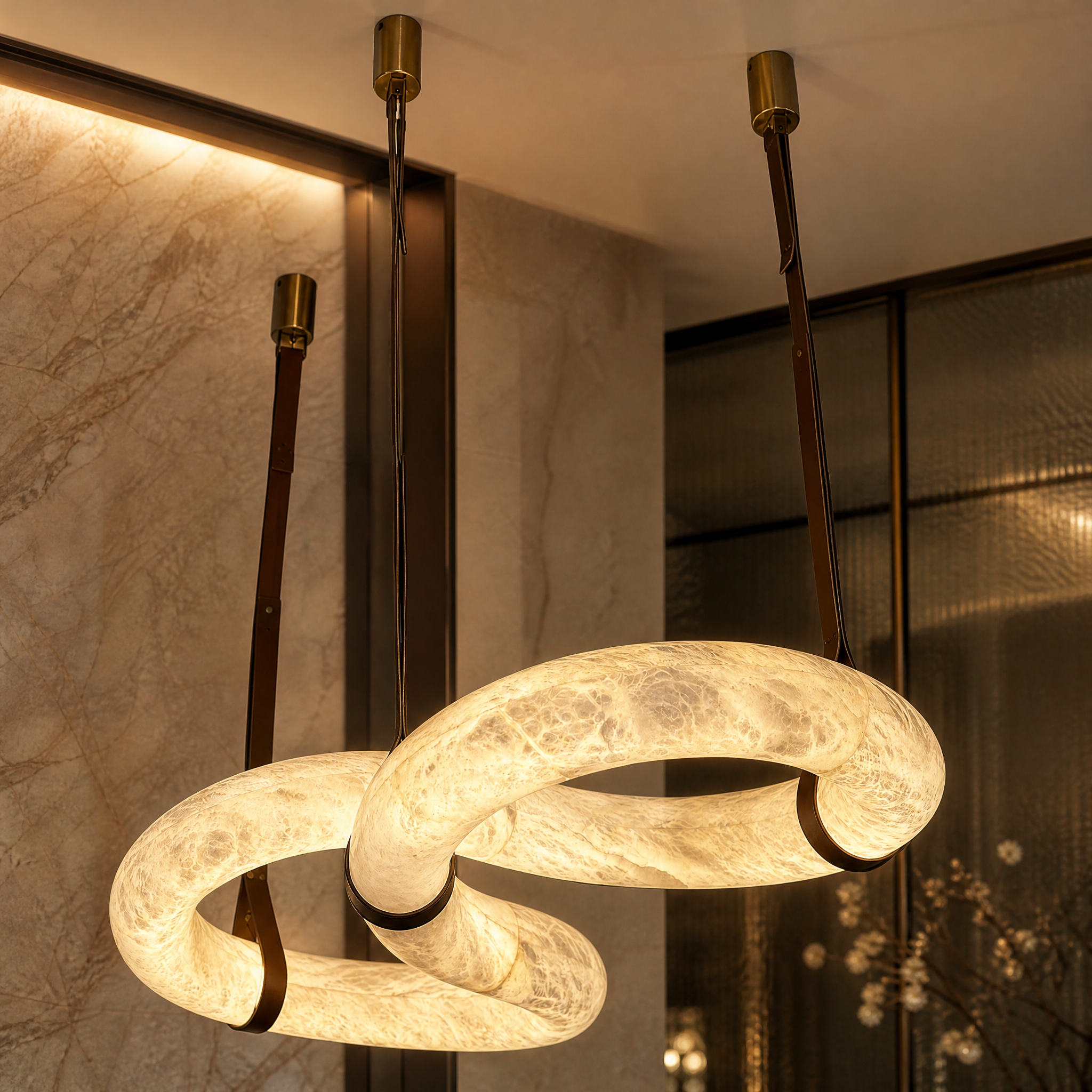 Detailed closeup showing the seamless natural veining and soft illumination of the Botticino marble chandelier.
