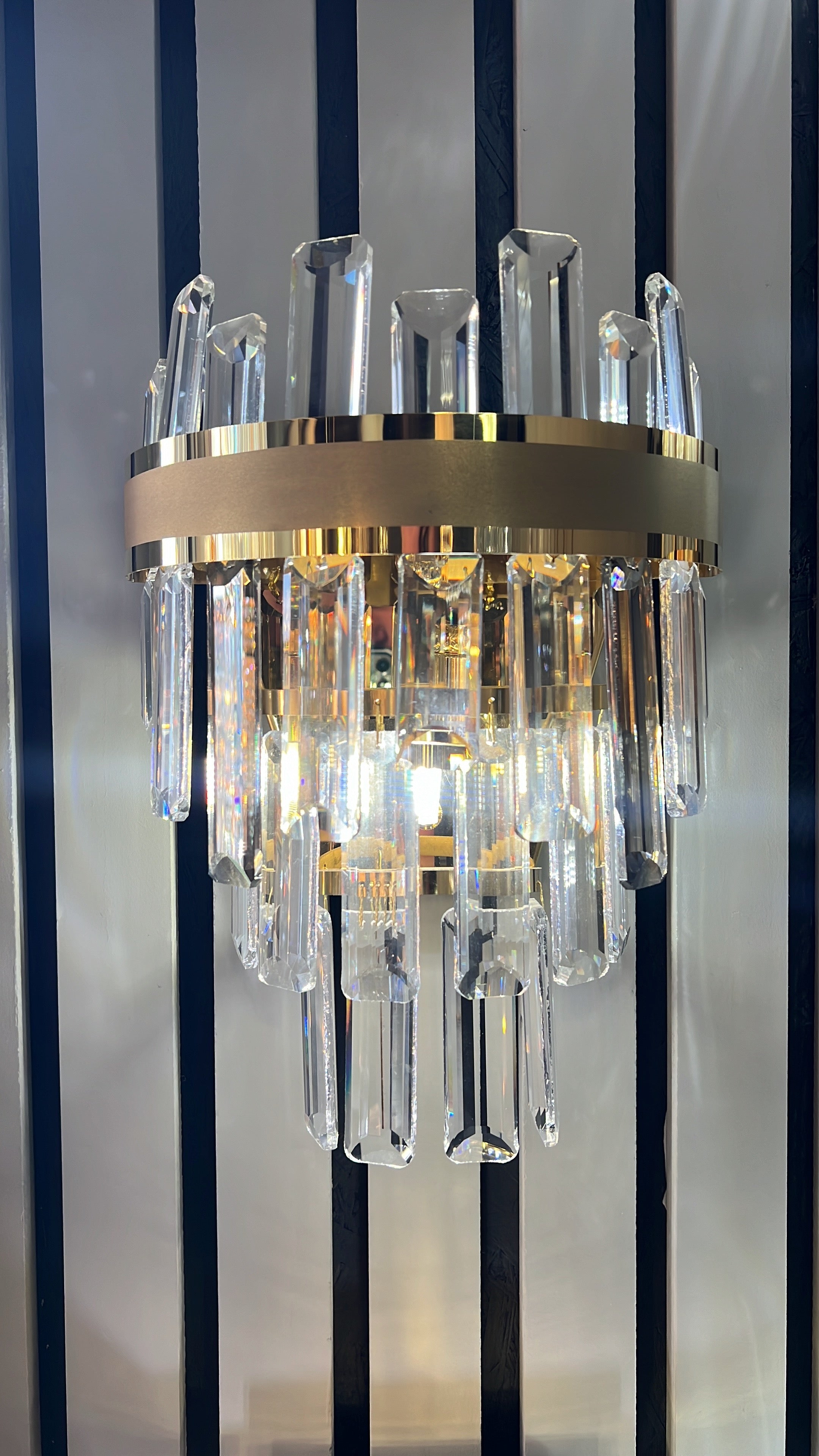 Close-up of the Brighouse wall light showcasing diamond cut crystal bars and luxury detailing