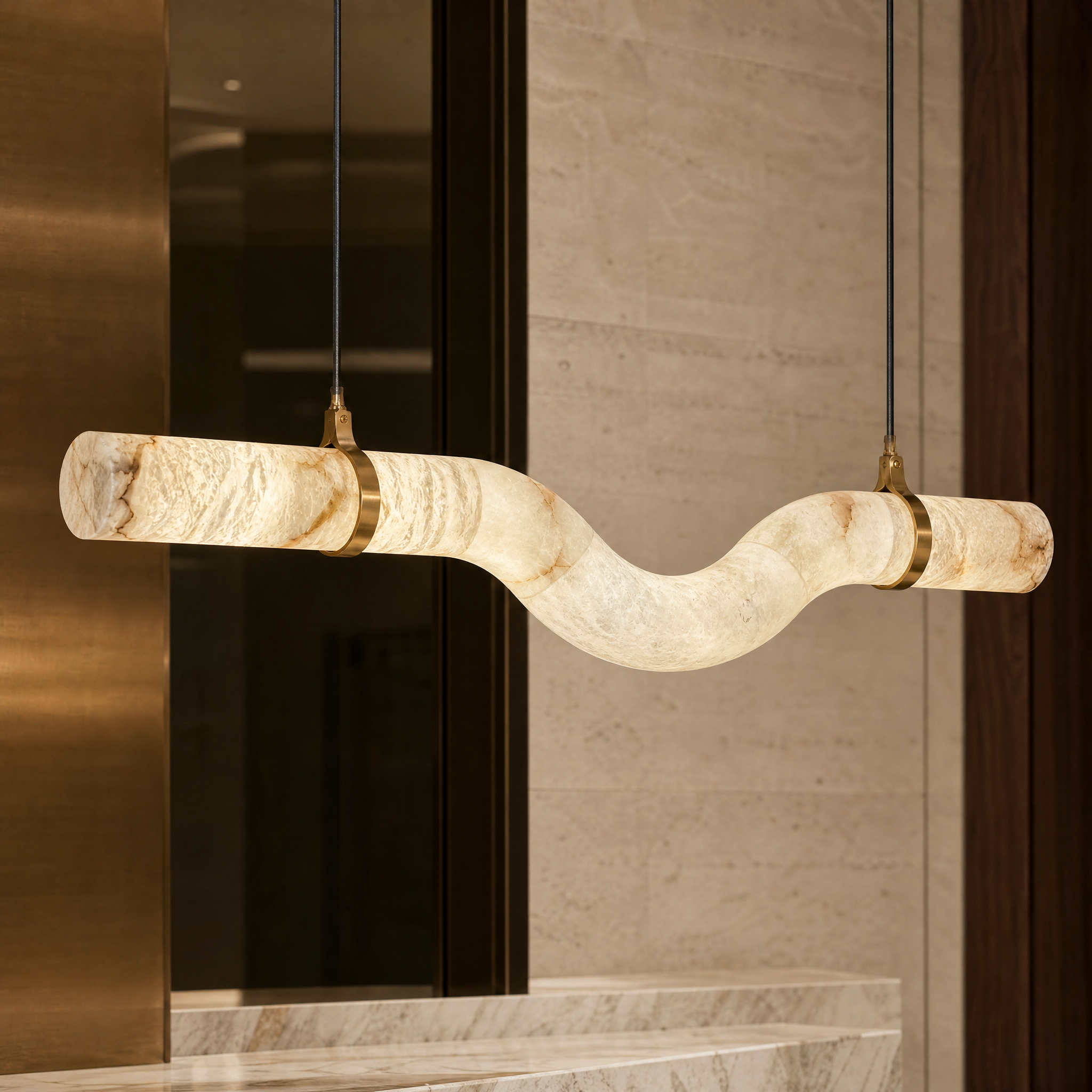 Close-up shot of the VORELLI Caesar chandelier showing the unique hand-carved natural marble texture and brushed brass suspension.