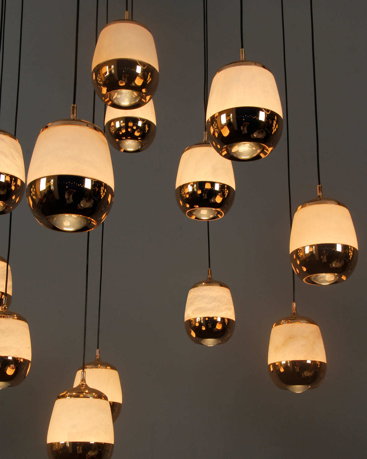 Close-up of Caldera marble pendants showcasing warm ambient illumination in a cascading formation.