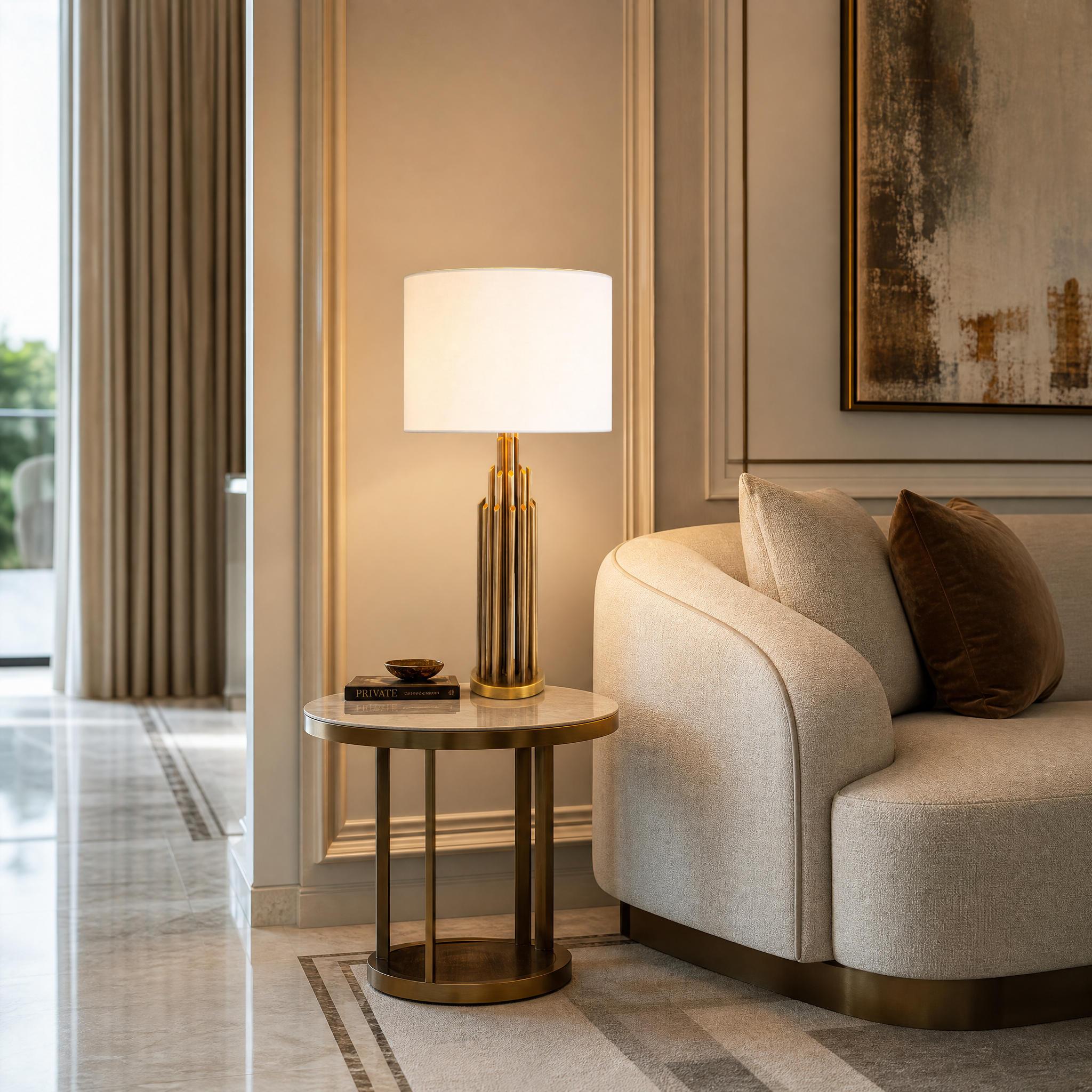 The VORELLI Calviero brass table lamp casting a warm, elegant glow in a modern, sophisticated residential living room interior.