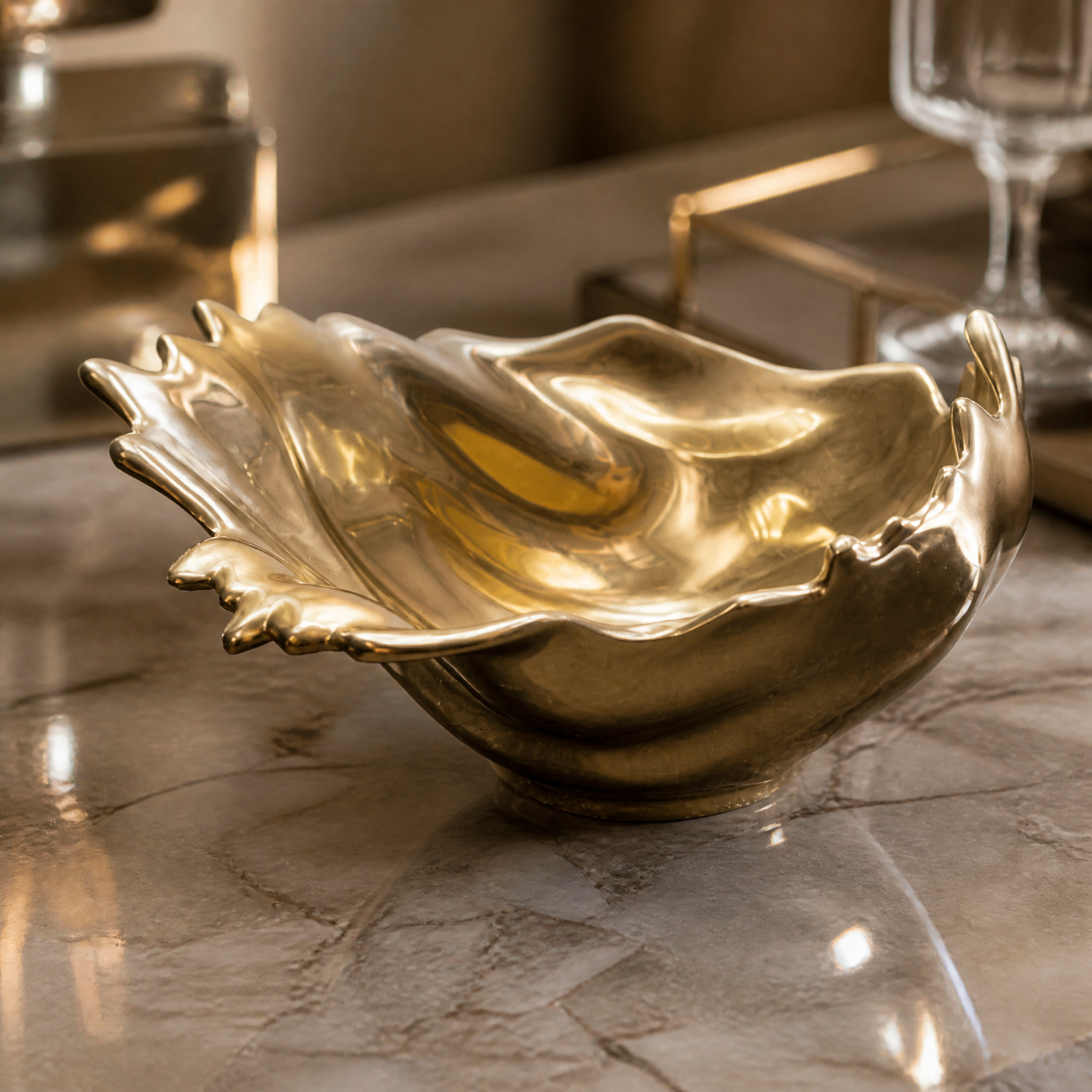 Close-up view of the Calvino Gold Bowl showcasing its polished metallic surface and intricate wave-like sculptural craftsmanship.