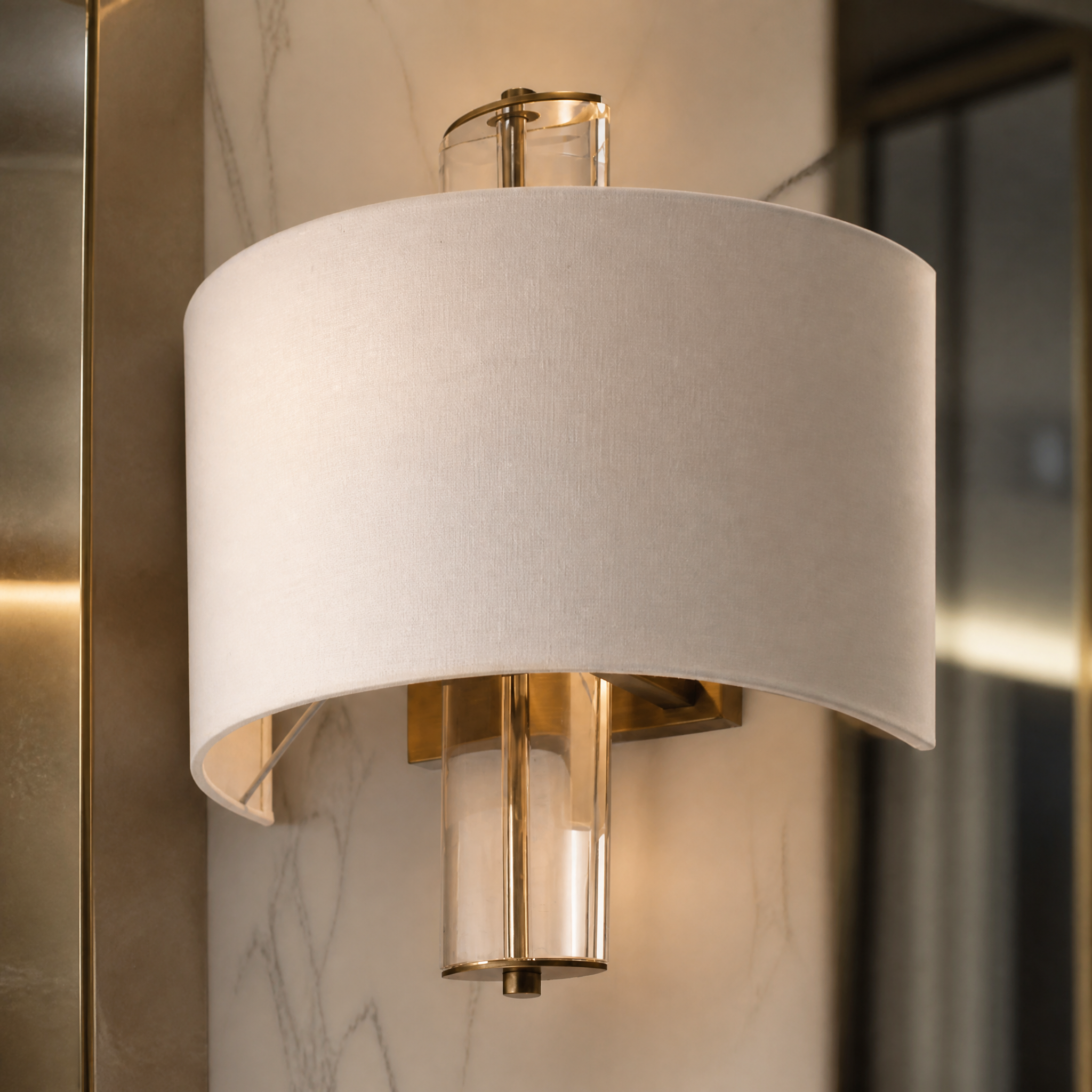 Detailed macro shot of the antique brass finish and clear crystal accents on the VORELLI Calviro wall light