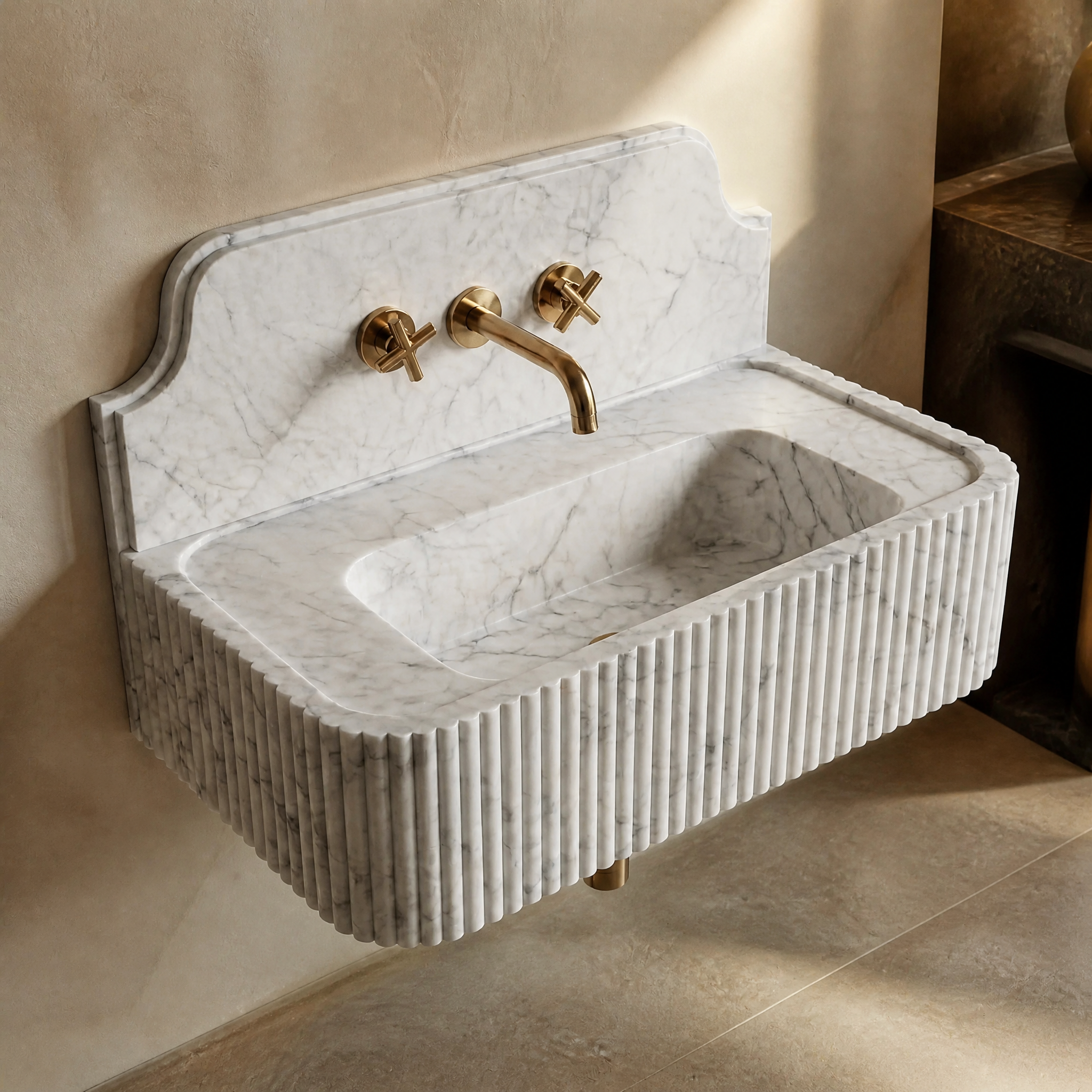 A detailed closeup of the VORELLI White Carrara marble sink, showcasing the unique fluted texture and natural light-grey stone variations.