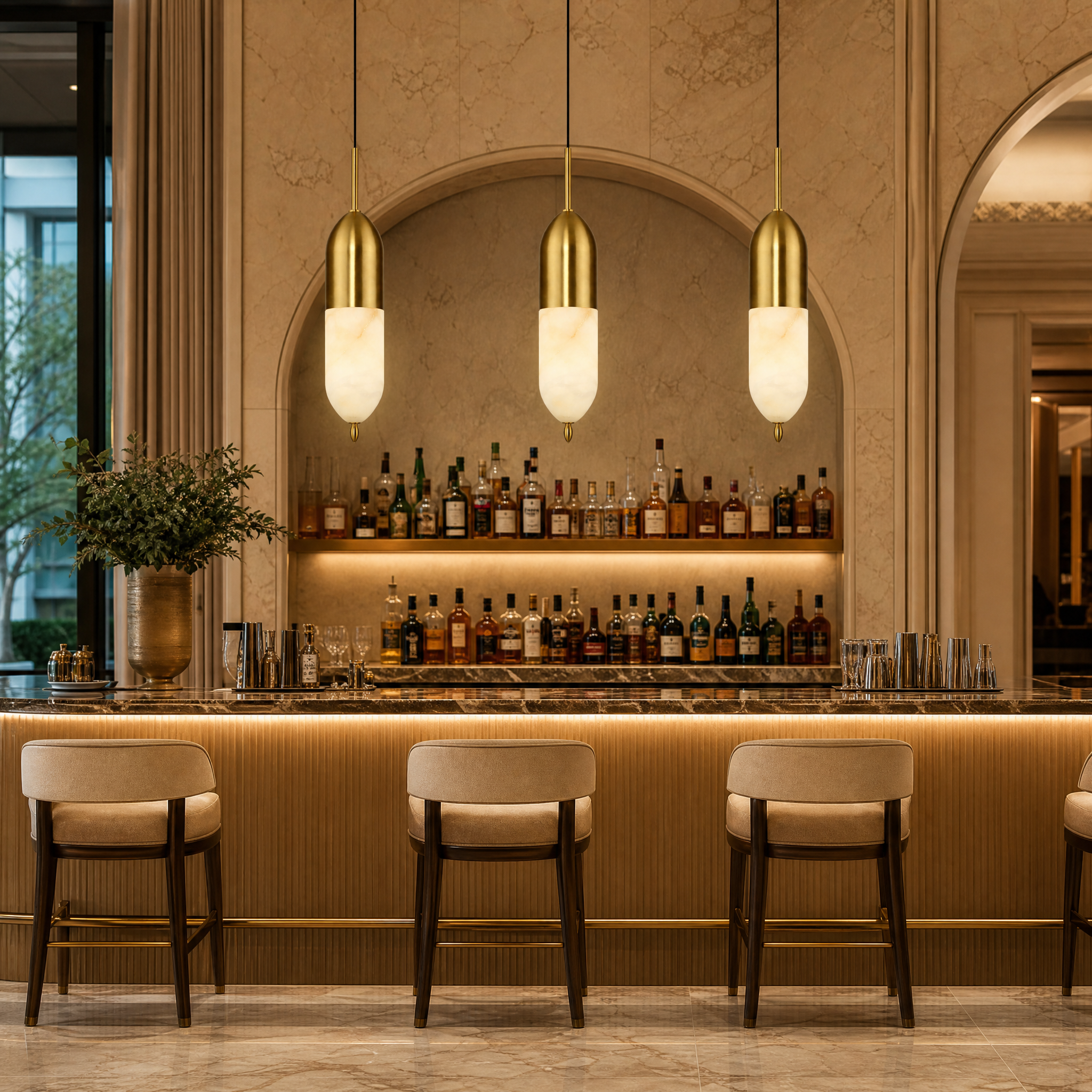 Elegant Castano chestnut-inspired marble pendant lights suspended in a sophisticated hospitality lounge setting creating an ambient glow.
