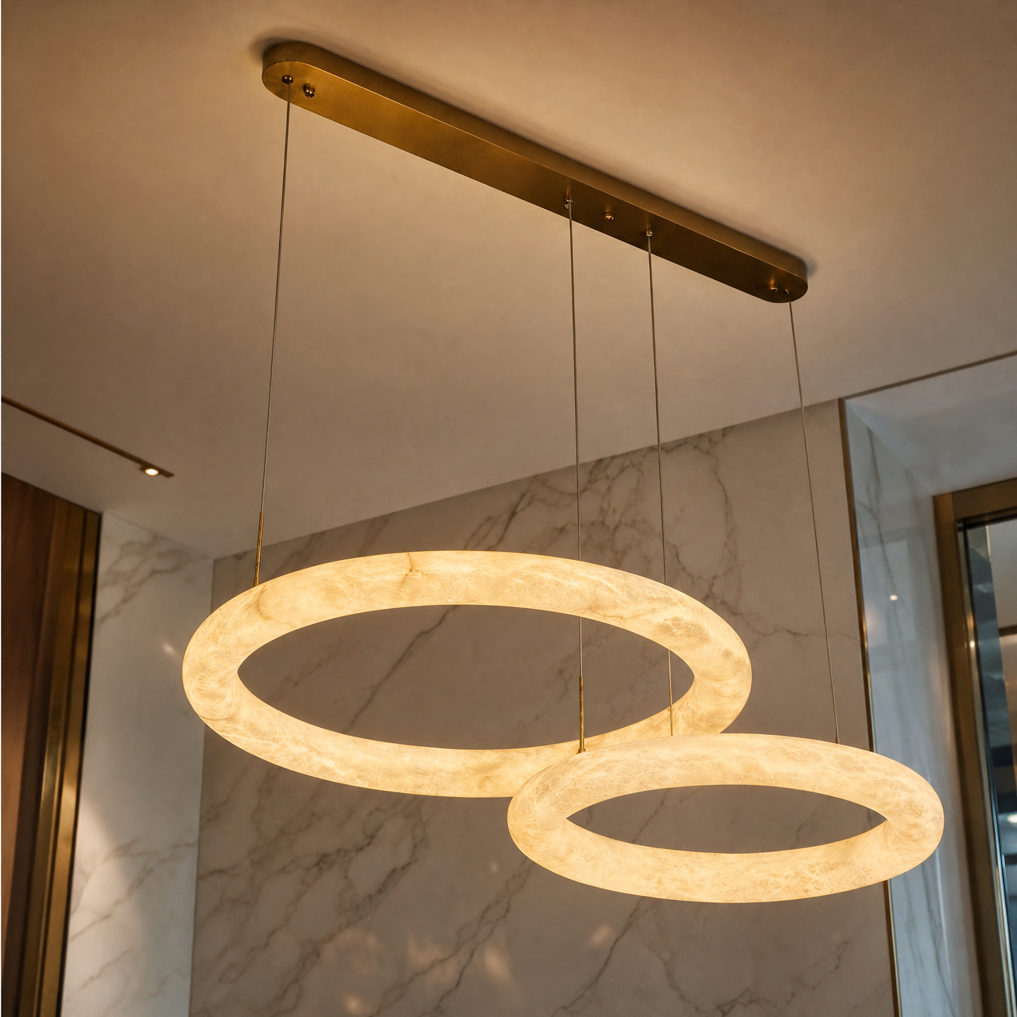 Macro closeup of the VORELLI Cavani Chandelier showcasing the refined texture of the two illuminated luminous marble rings.