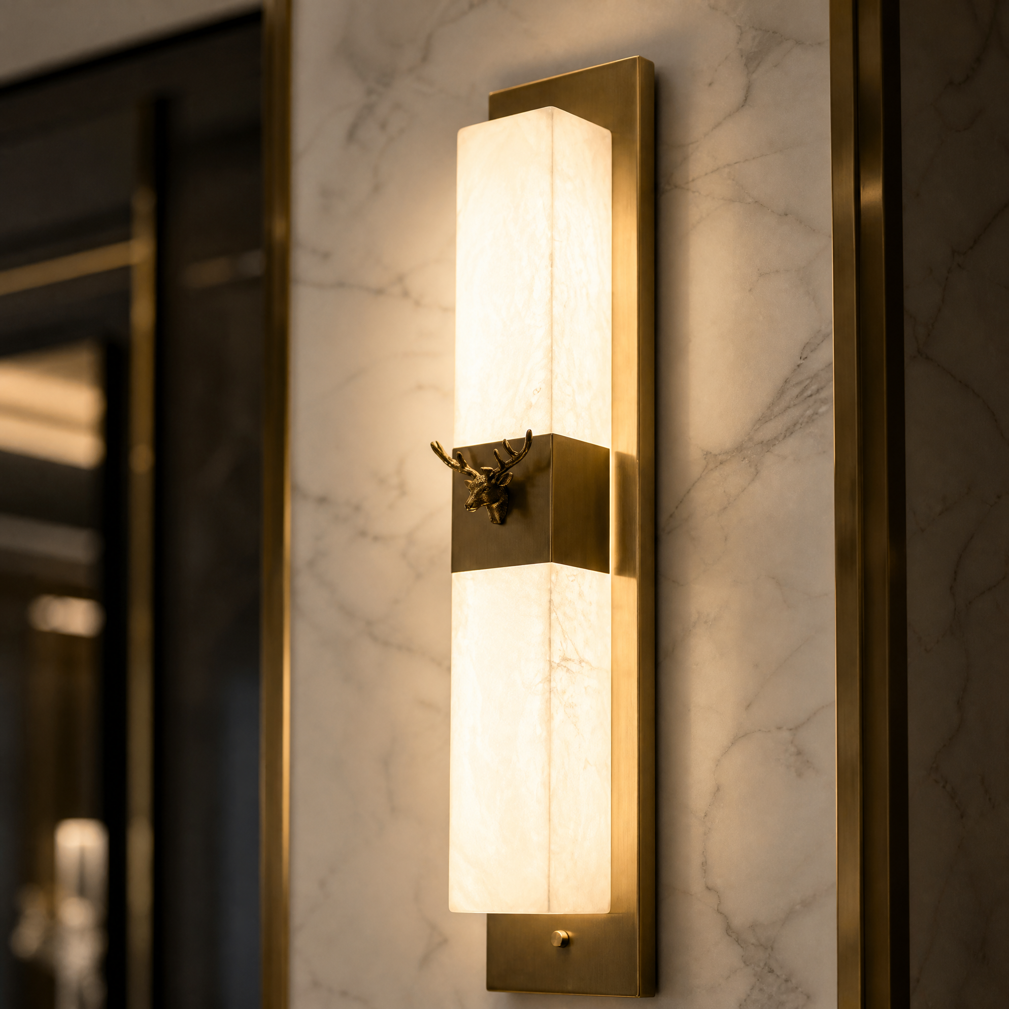 Macro view of the sculpted natural marble texture and stainless steel finish on the Cervo wall light.