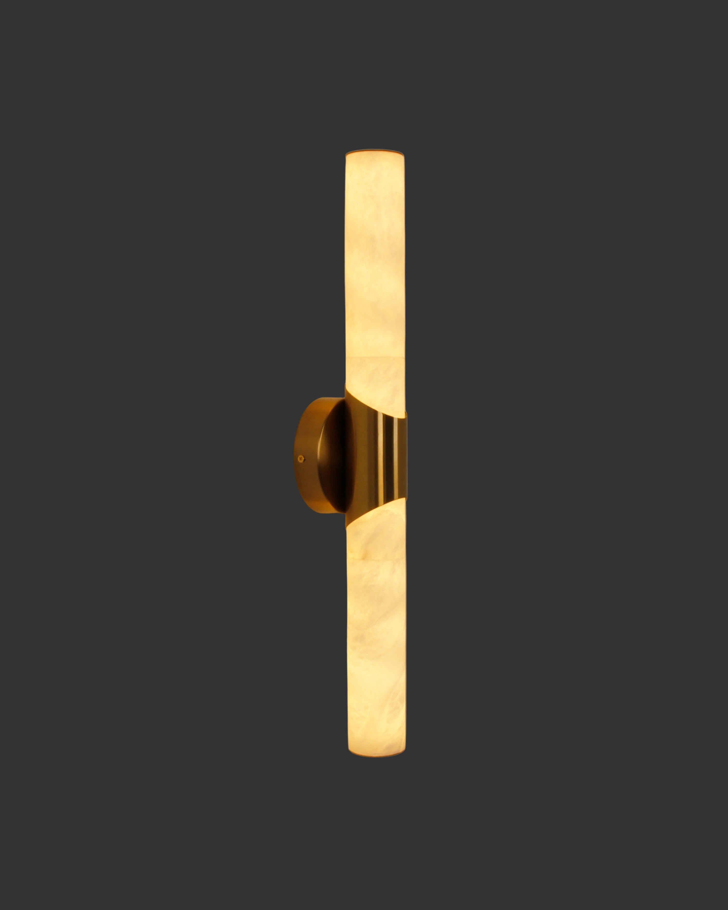 cilindro marble wall light in tall cylindrical form with warm illuminated marble