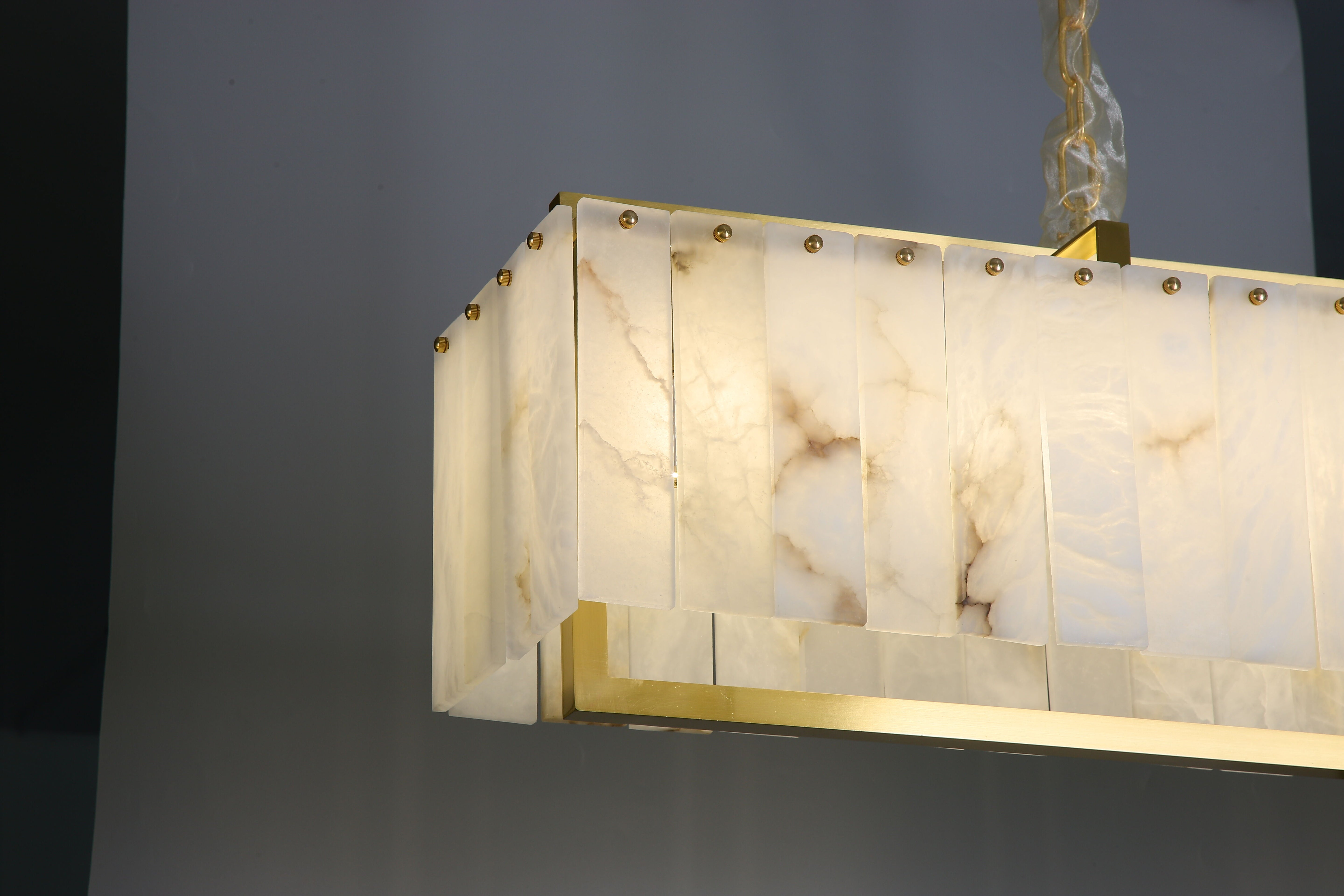 classisco rectangular marble chandelier illuminated with warm ambient glow