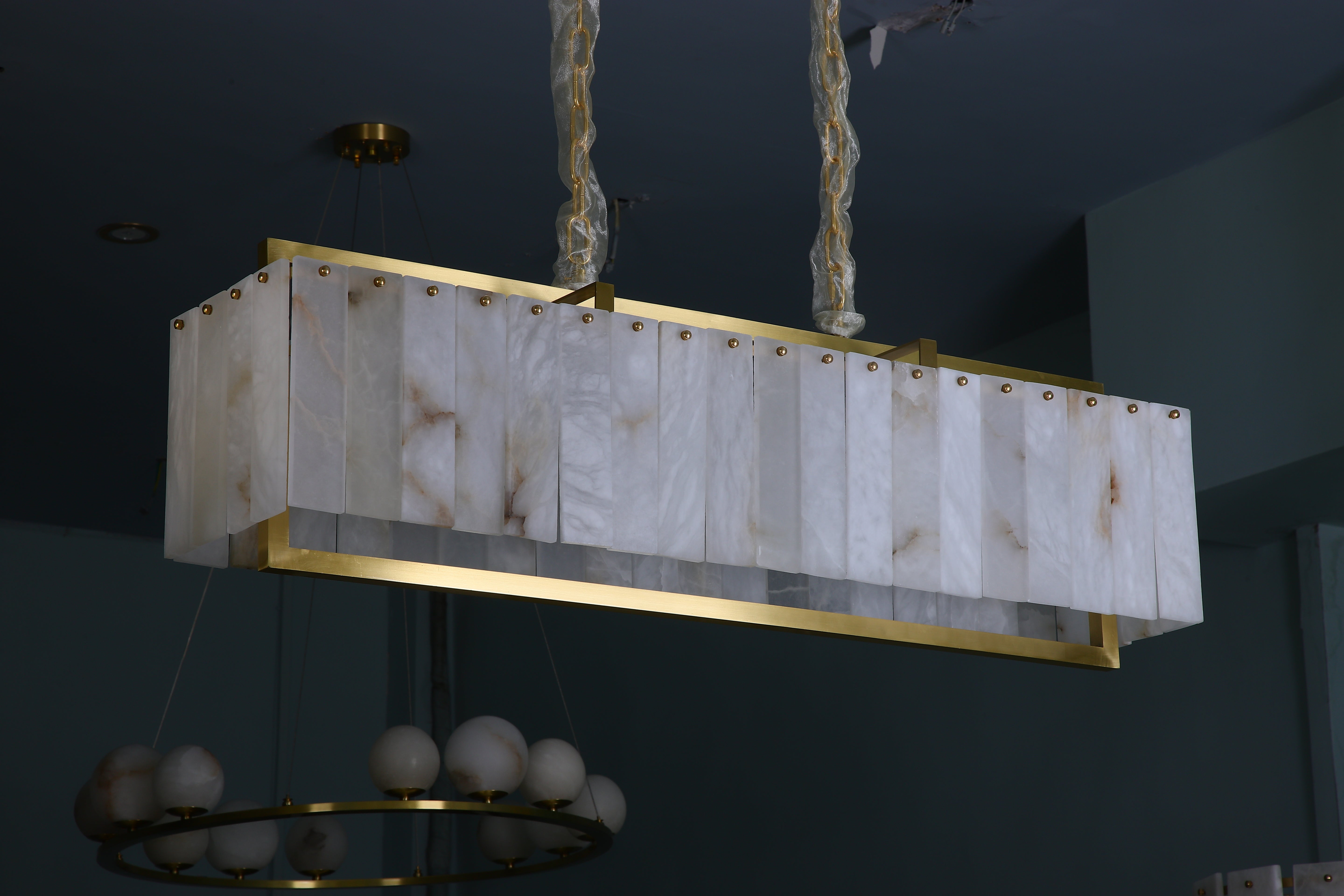 classisco marble chandelier with gold accents viewed from below