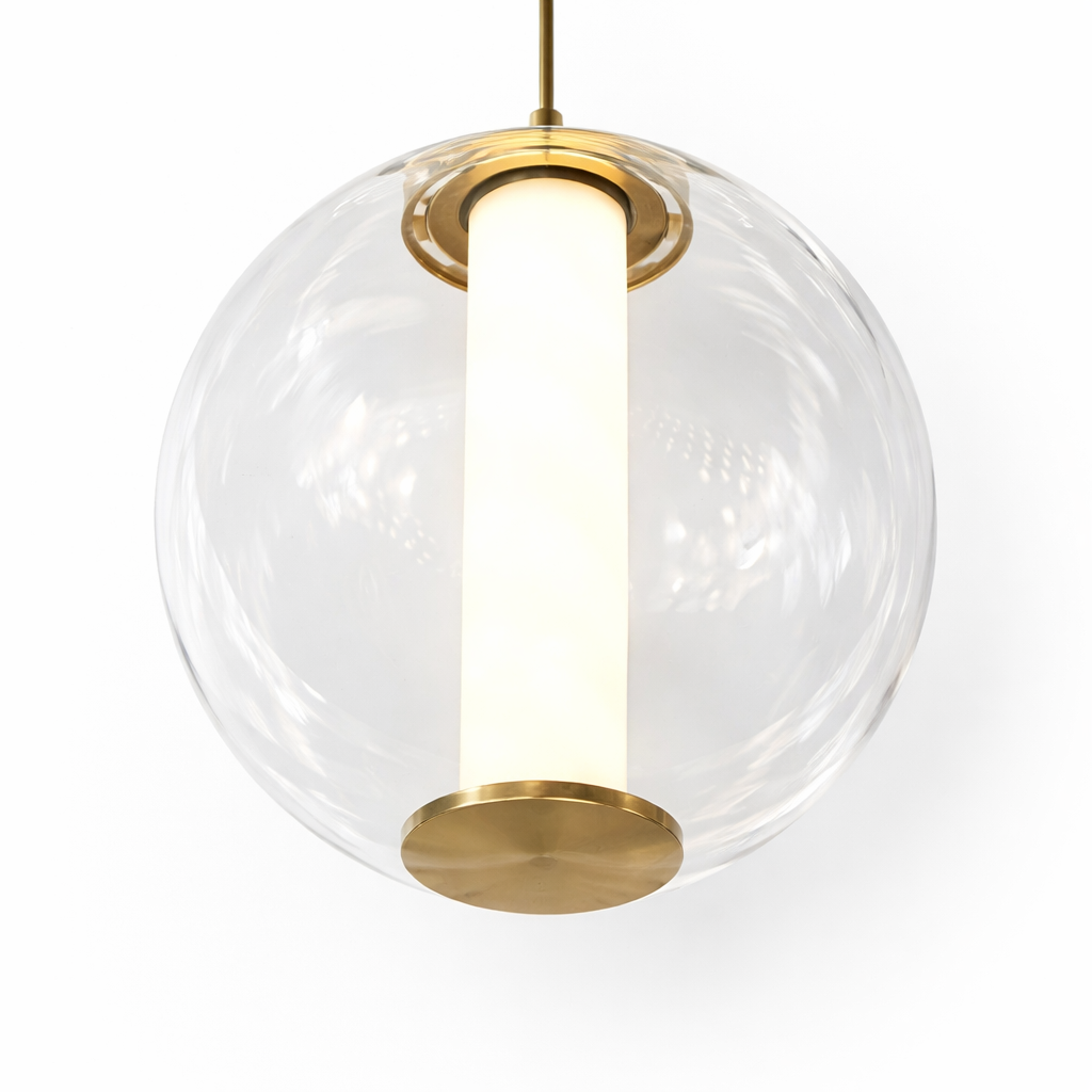 Close-up of the Maximus Marble Pendant Light highlighting the natural veining of the cylindrical marble core glowing warmly inside a clear glass globe.
