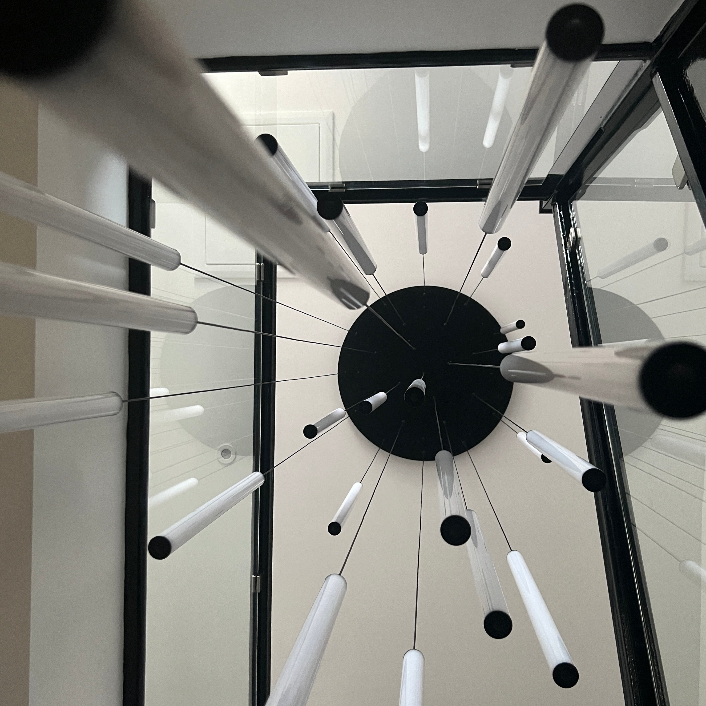 close up of cowley staircase pendant showing slim cylindrical body and soft illumination