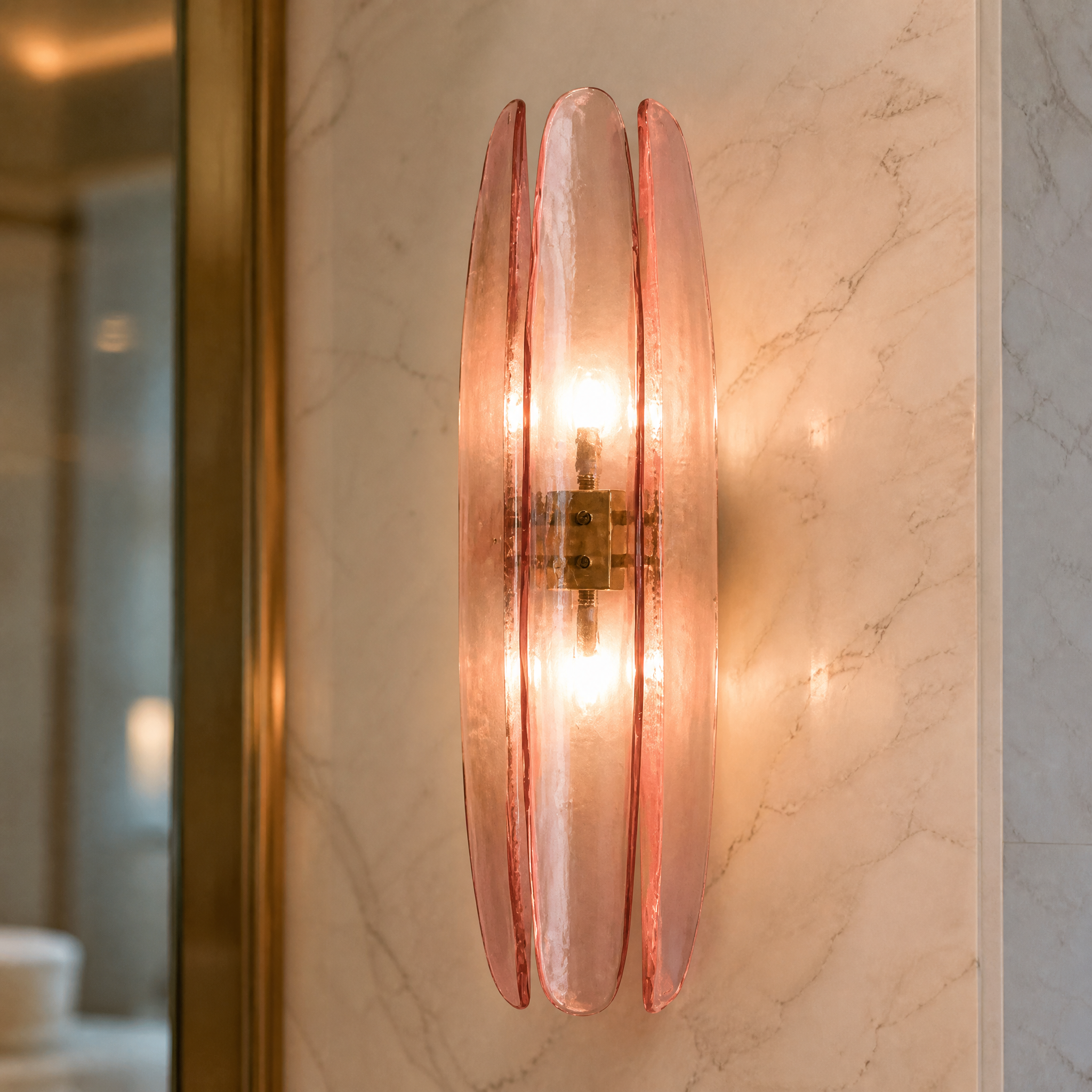 Macro closeup of the Dalia wall light showcasing the three long petal-shaped curved pink glass shades and minimal brass fixture details.