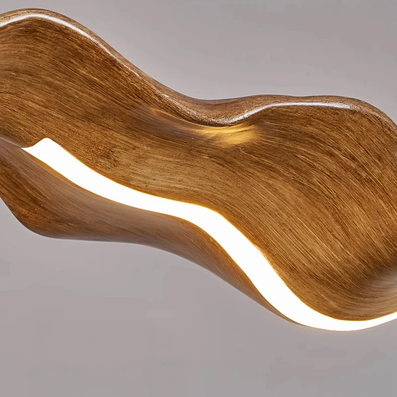 flowing sculptural chandelier with illuminated curved wooden form