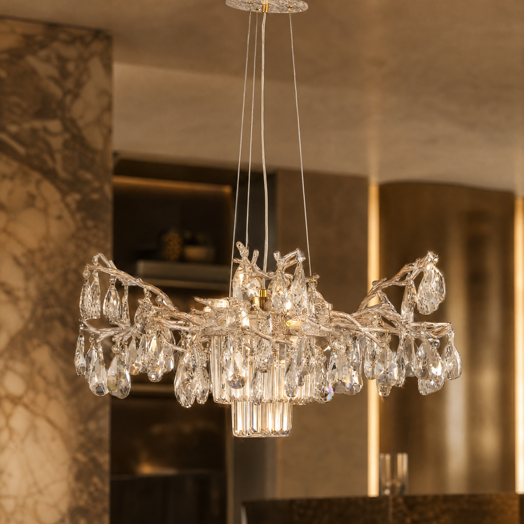 A detailed closeup of the Dewdrop Circular Chandelier II highlighting the cascading diamond cut crystal drops and sculpted branching arms.