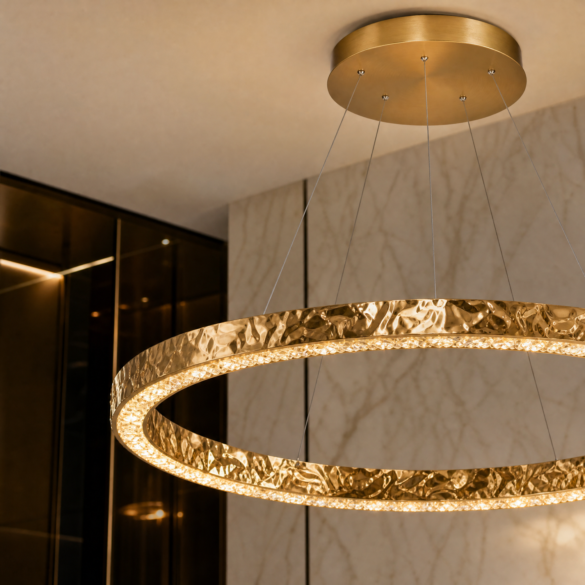 Close-up view of the Ecliptica chandelier frame highlighting the intricate, high-quality textured gold surface craftsmanship.