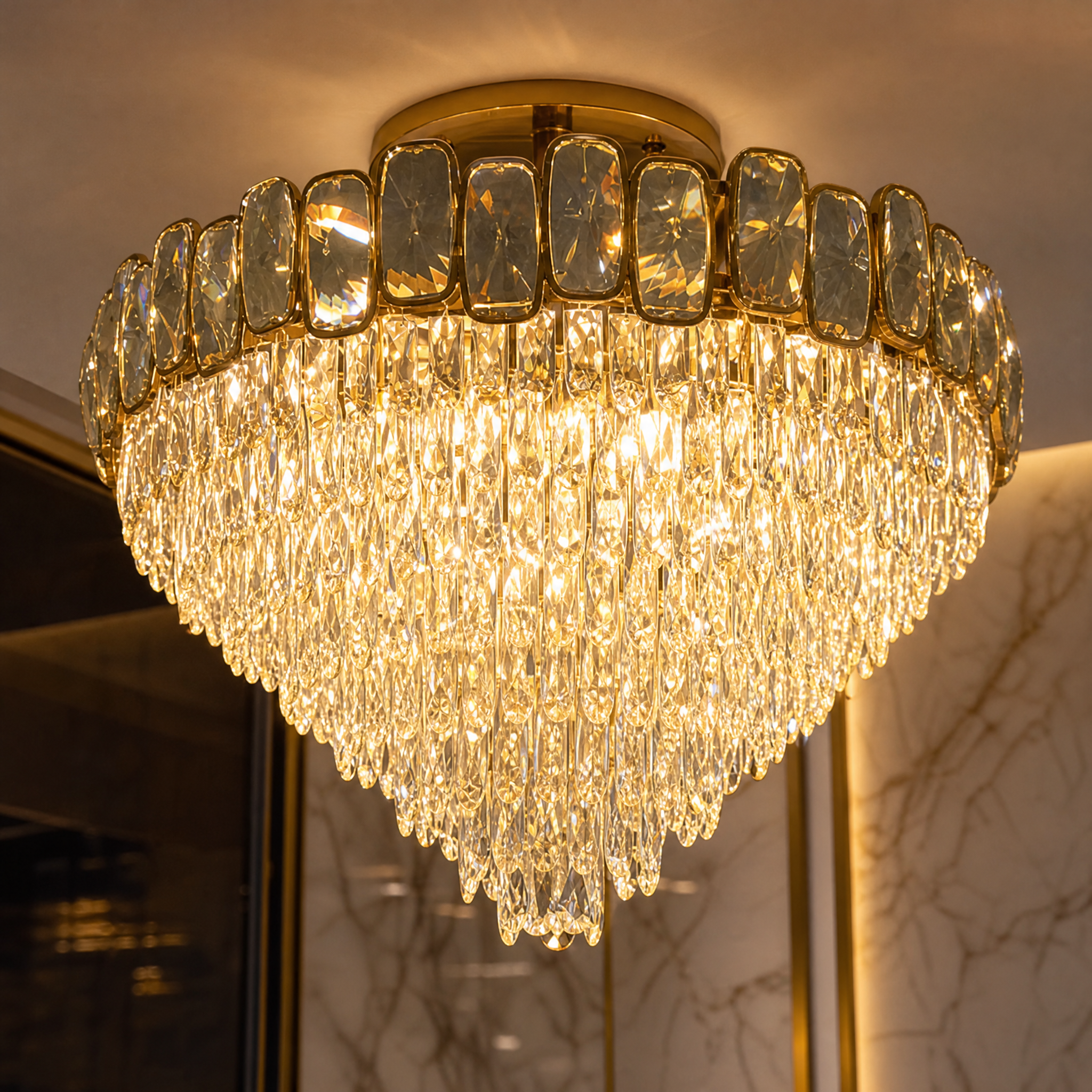 Macro view of the VORELLI Edmond Chandelier detailing the intricate oblong and semi-ellipse diamond-cut crystals reflecting light.