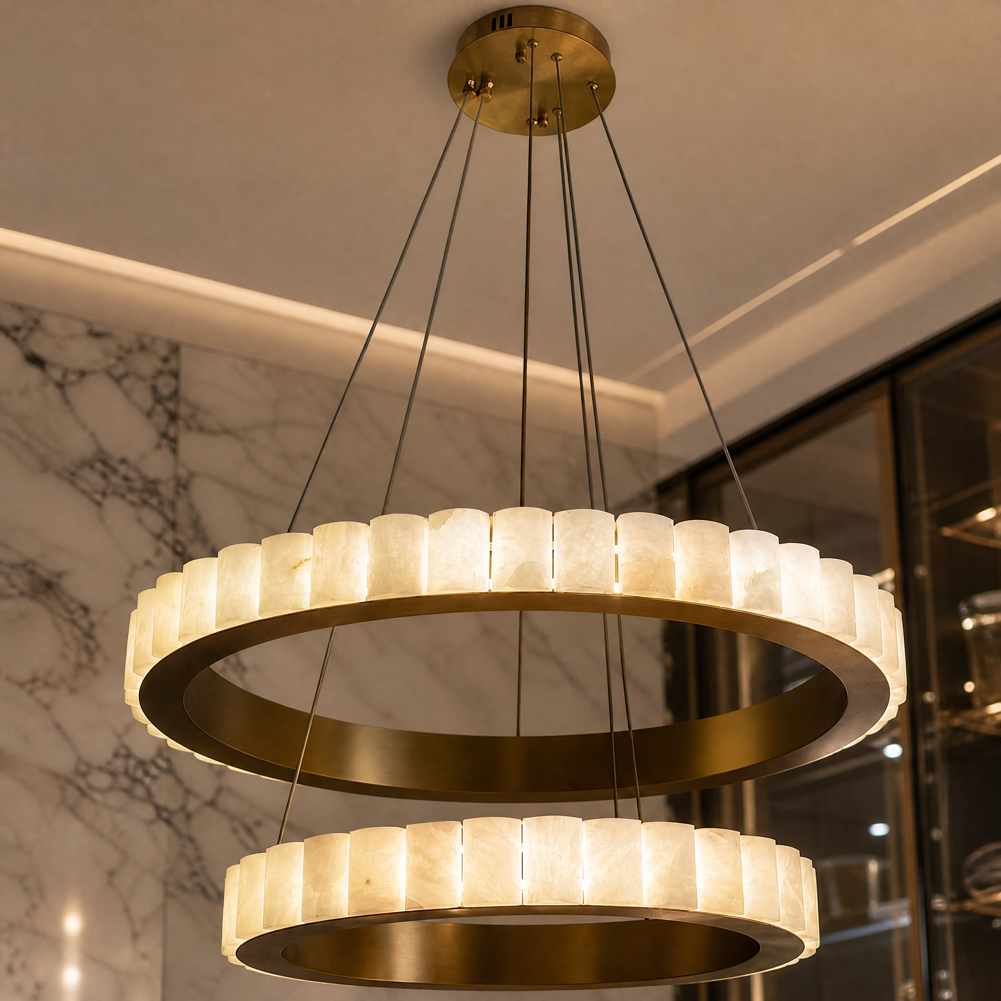 A detailed close-up of the VORELLI Elysia Chandelier, highlighting the seamless double-ring formation and intricately carved translucent marble segments.