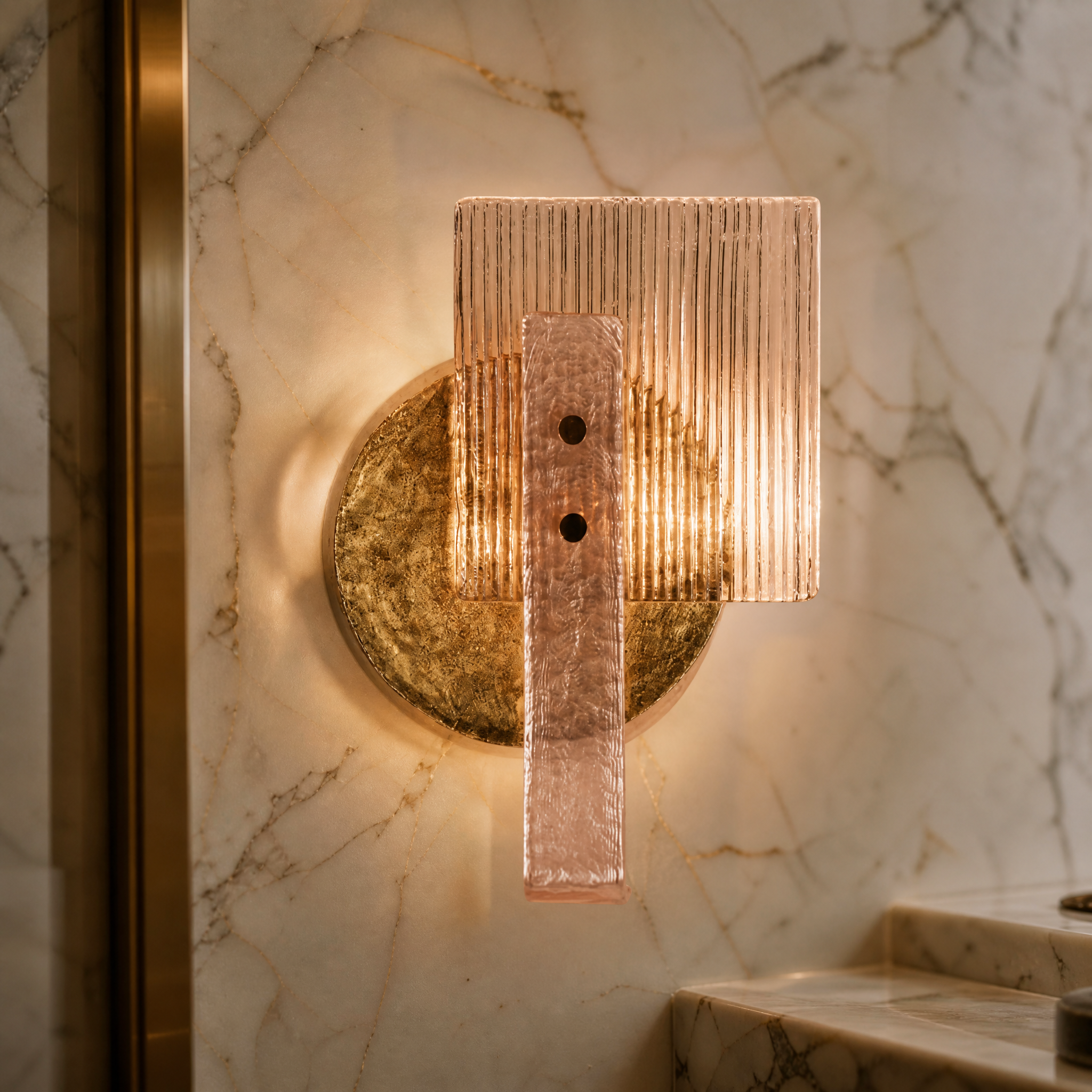 Macro closeup of the Erinna wall light showcasing the fine details of the ridged glass panel, textured pink glass arm, and hand-finished brass disc.