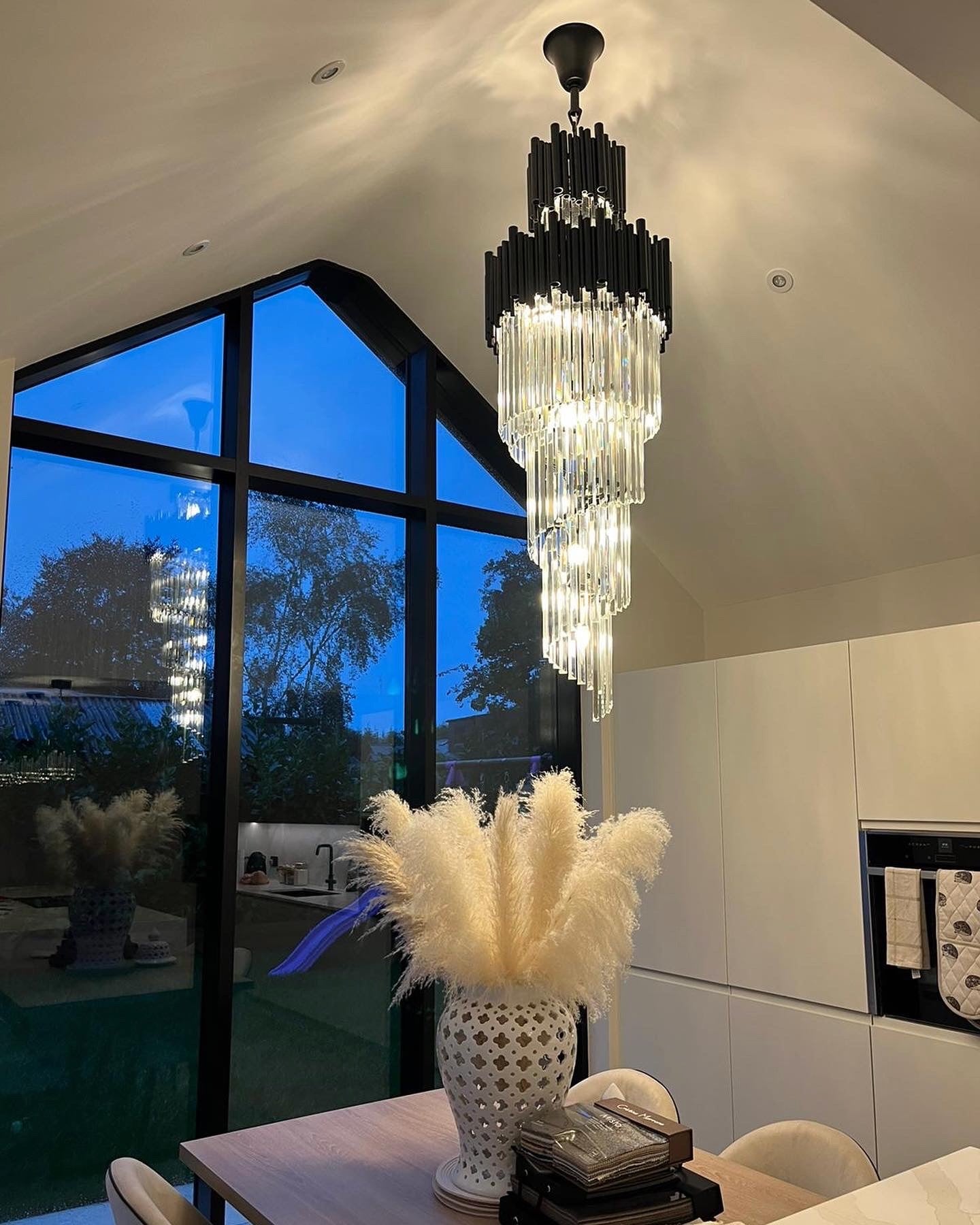 Designer crystal chandelier lighting a contemporary dining space