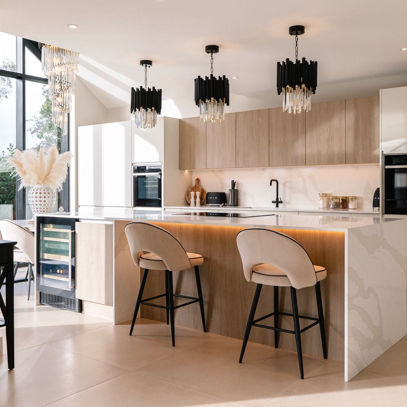Modern Gotham pendant lights installed above a kitchen island