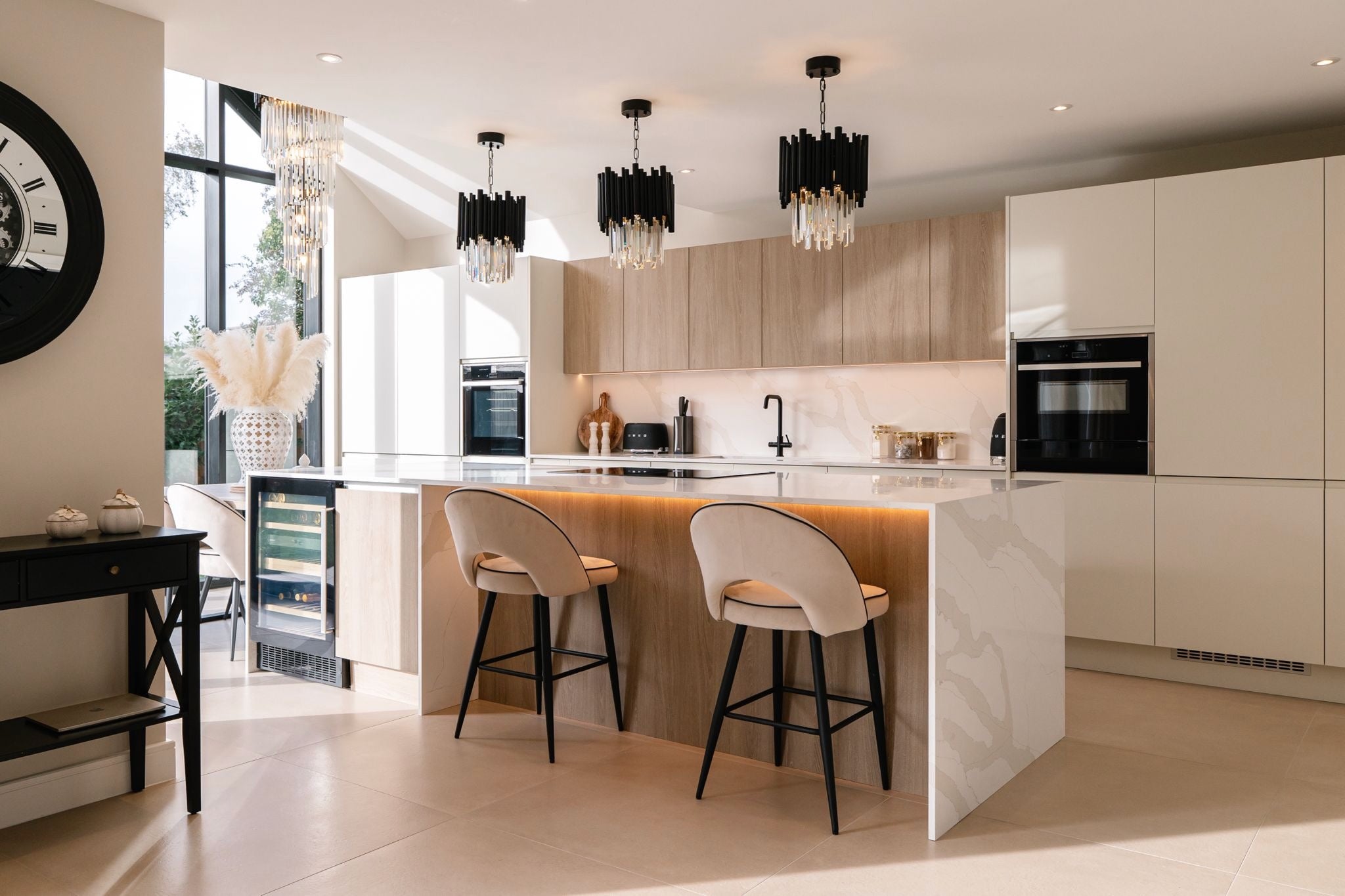 Modern Gotham pendant lights installed above a kitchen island