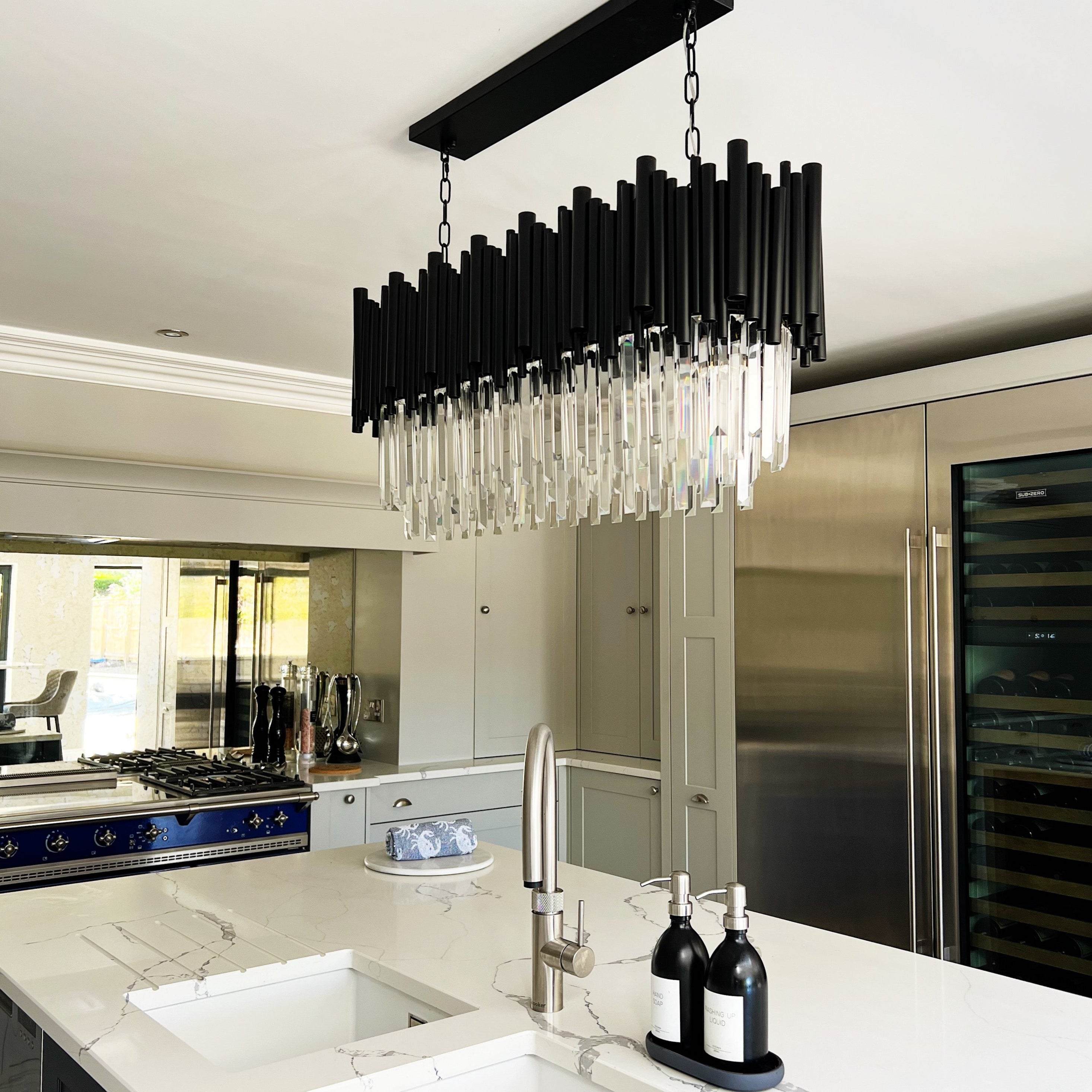 Gotham rectangular chandelier styled over a contemporary kitchen island