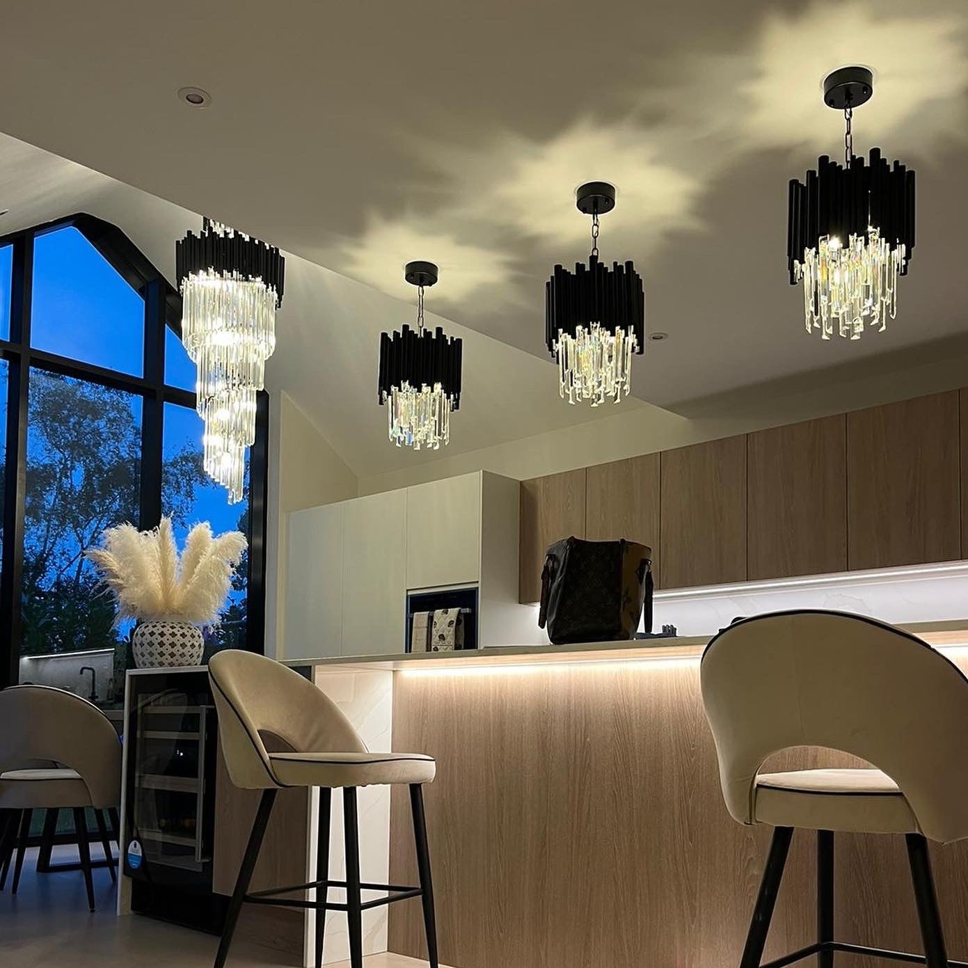 Vertical crystal staircase chandelier installed in contemporary interior