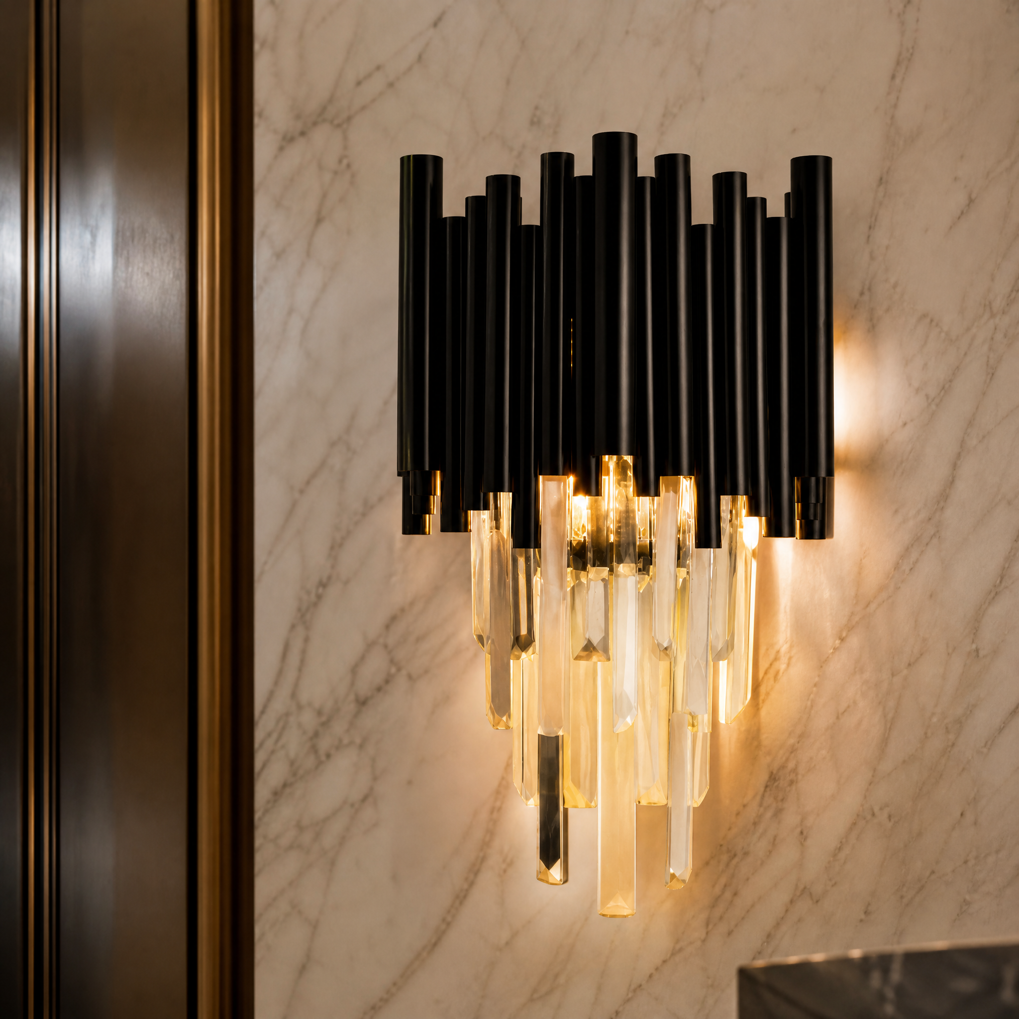 A detailed close-up of the VORELLI Gotham wall light, showcasing the exquisite crystal bars and the sleek, sophisticated craftsmanship of the fixture.