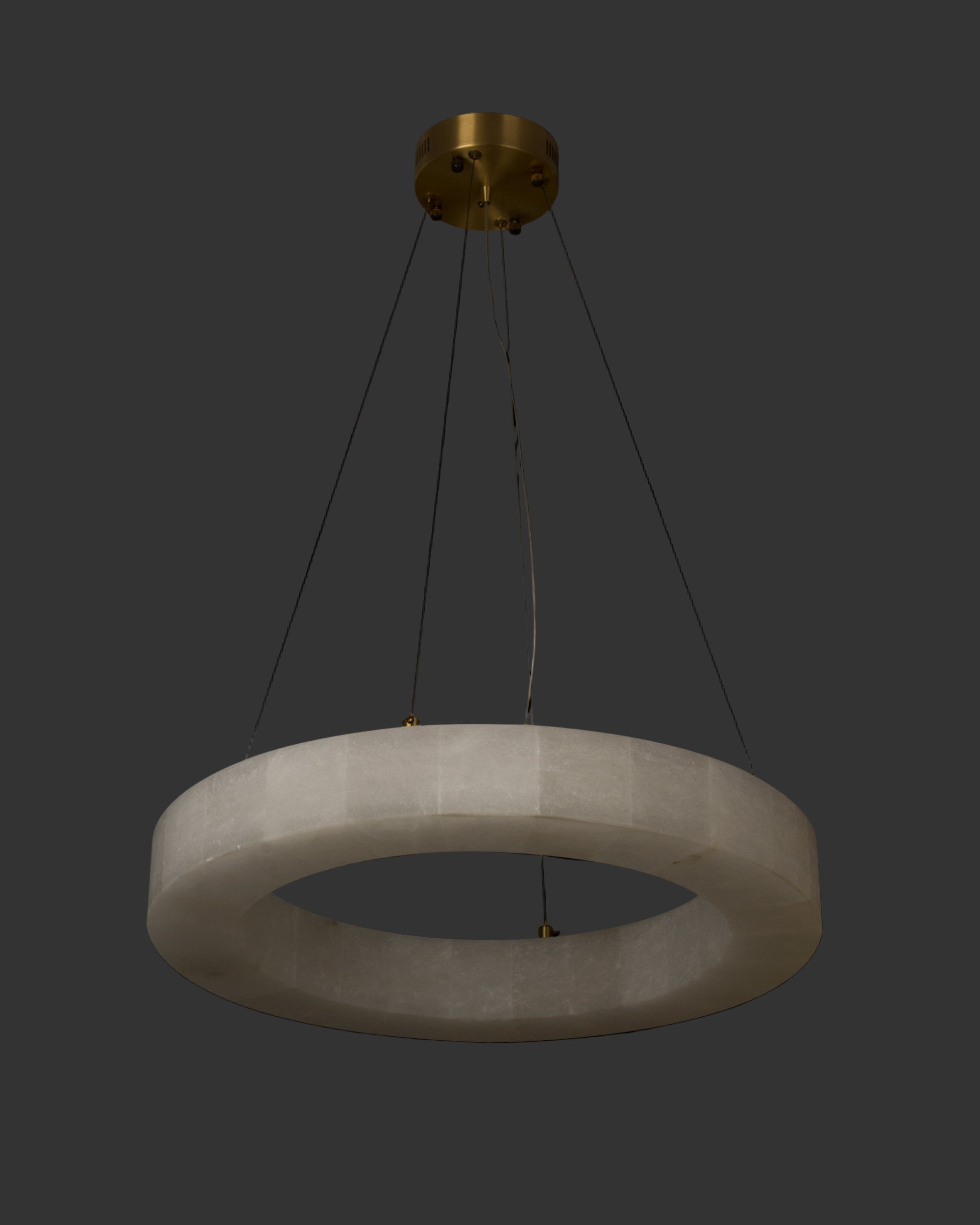 Halo Marble Circular Chandelier suspended from the ceiling with a seamless circular marble halo