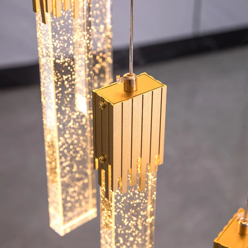 Detailed view of the illuminated crystal bar pendants on the Halstead Staircase Chandelier