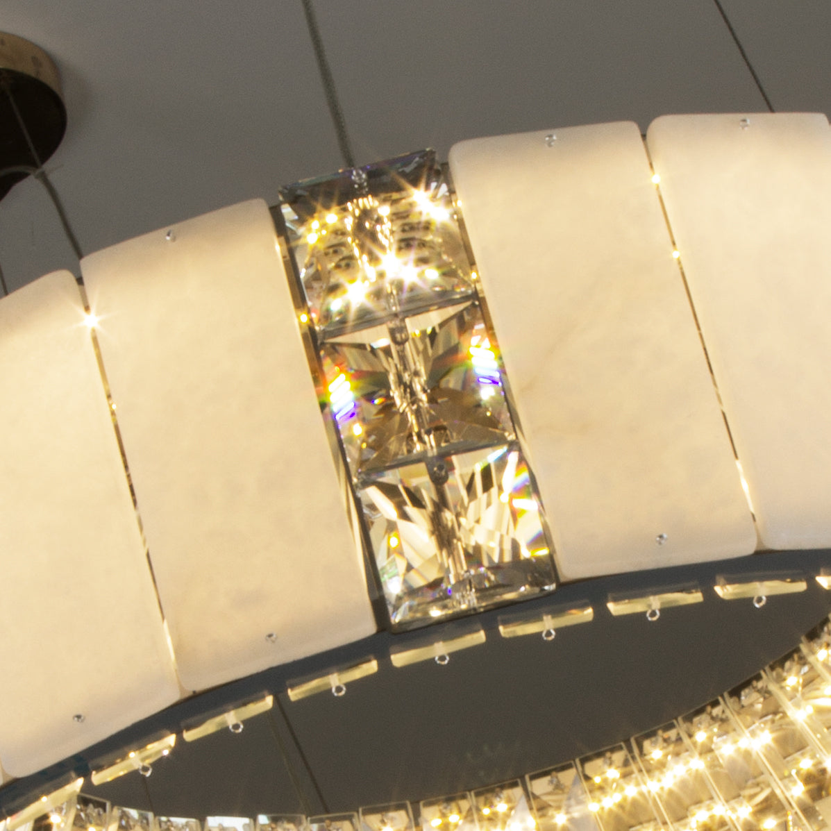 Close-up of marble panels and diamond cut crystal elements on the Helios Marble Circular Chandelier