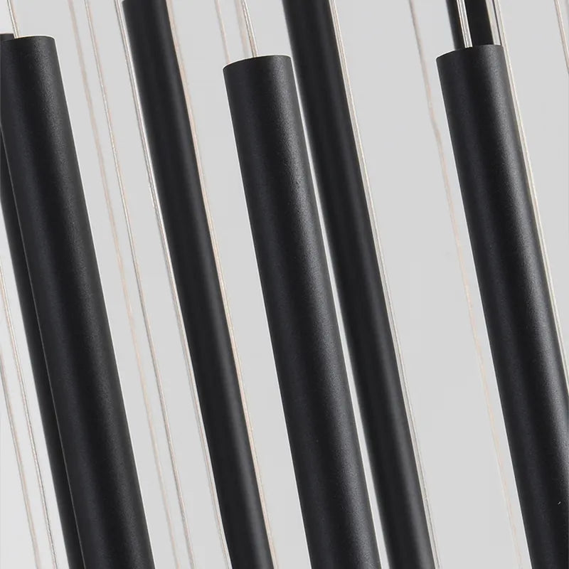 Cluster of slim cylinder pendant lights designed for contemporary staircase lighting