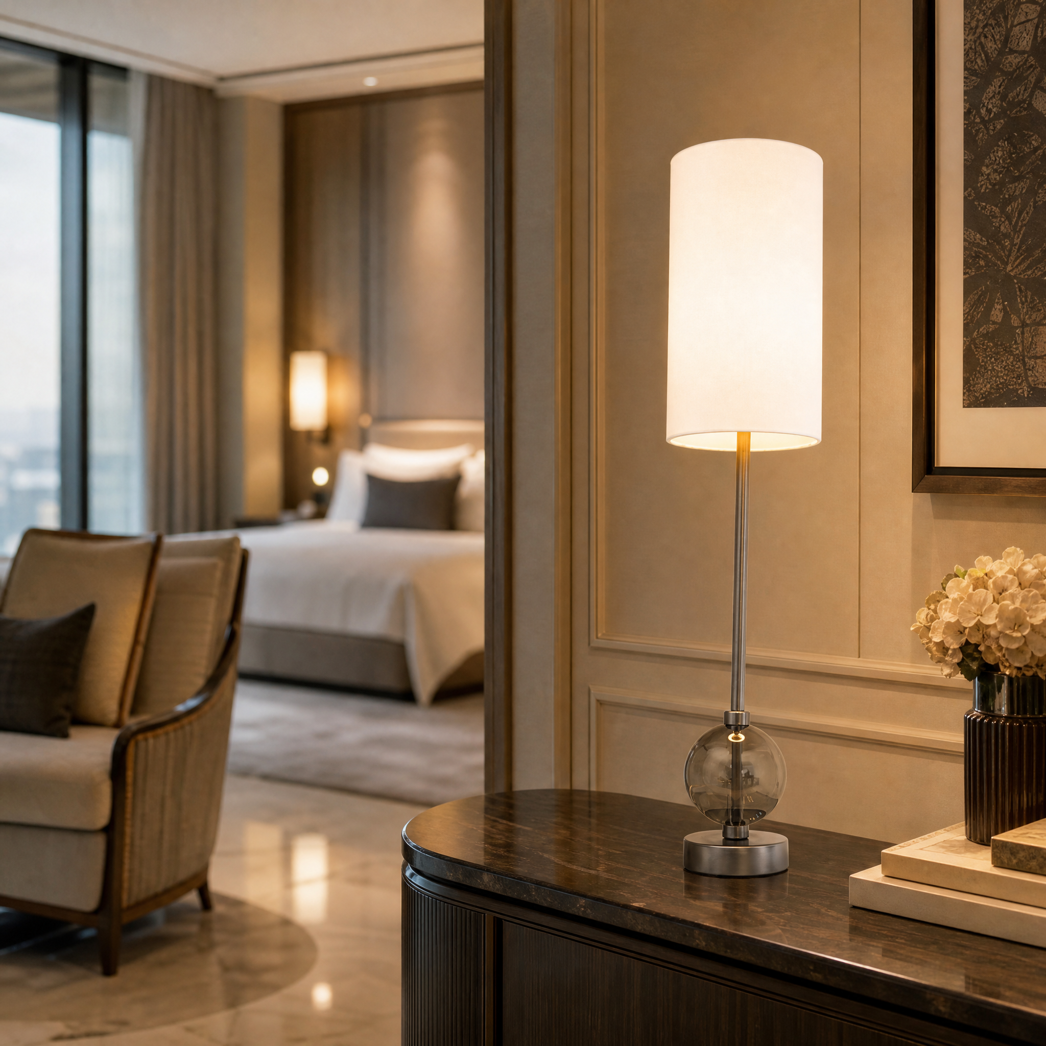 Contemporary hotel suite interior highlighting the Aurezza table lamp with sculptural crystal base and polished gunmetal accents.