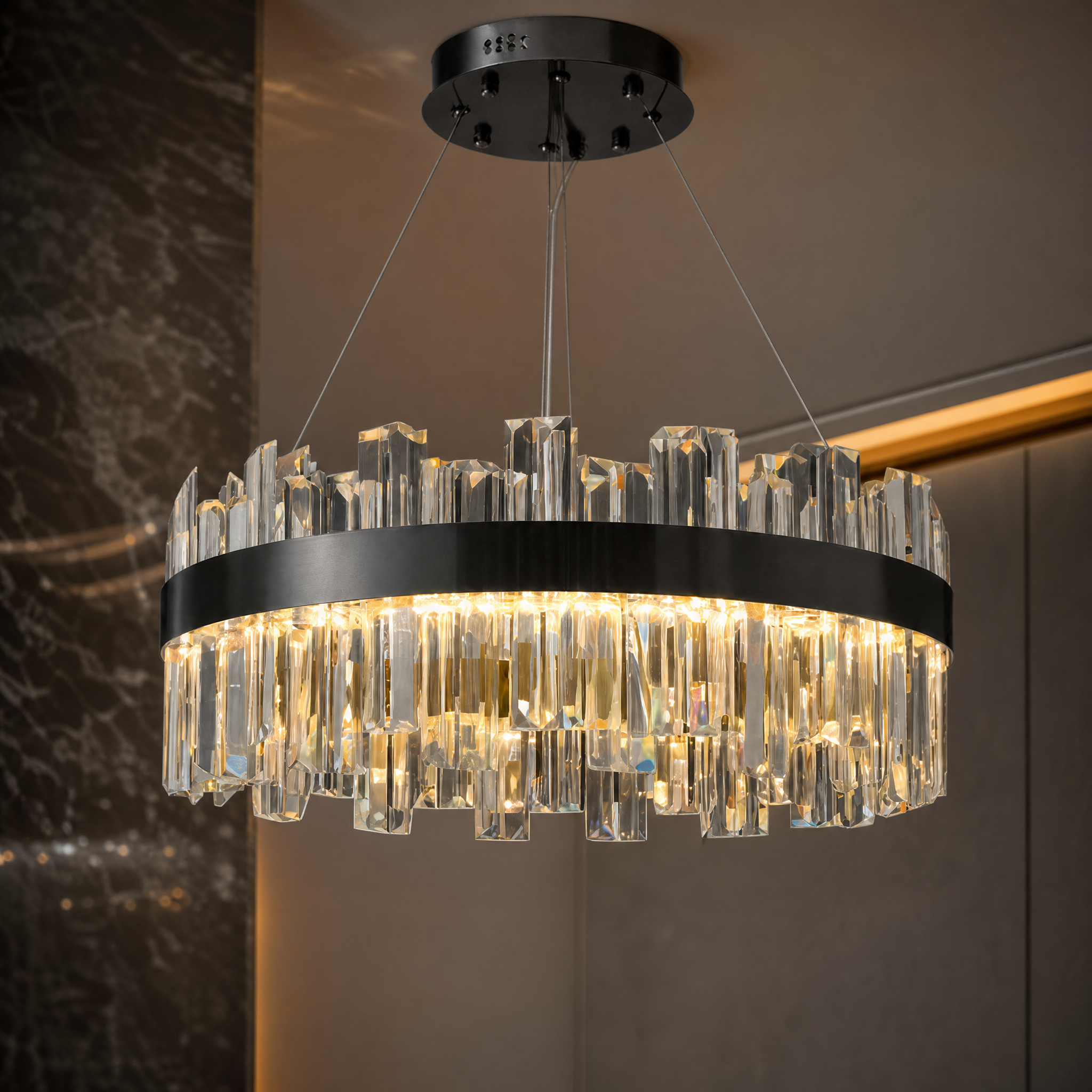 A detailed closeup of the VORELLI Medina Chandelier, highlighting the precision-cut crystal bars extending past the refined stainless steel frame.