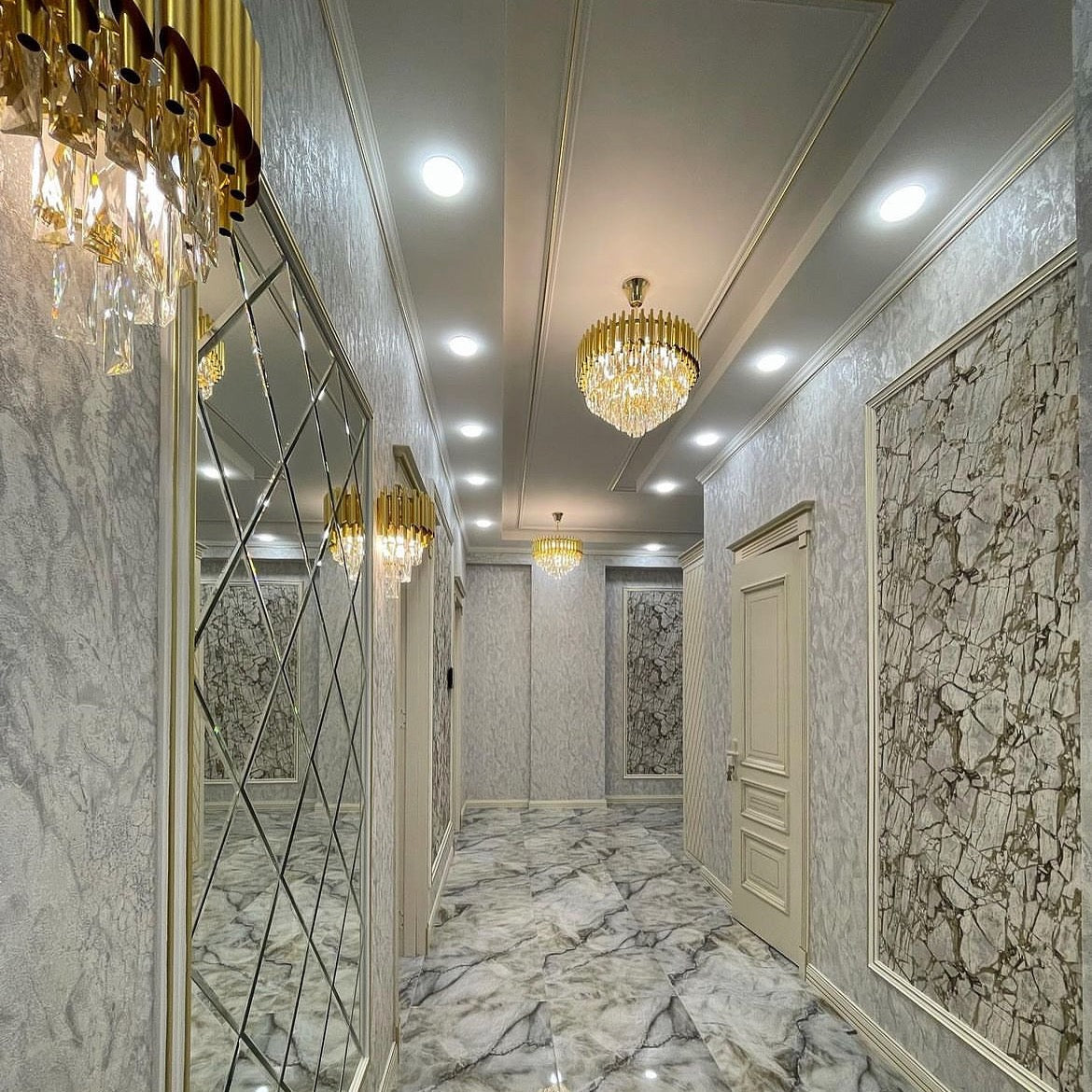 Milltimber wall light featuring sleek cylinder tubing and diamond cut rectangular crystals in a luxury hallway setting