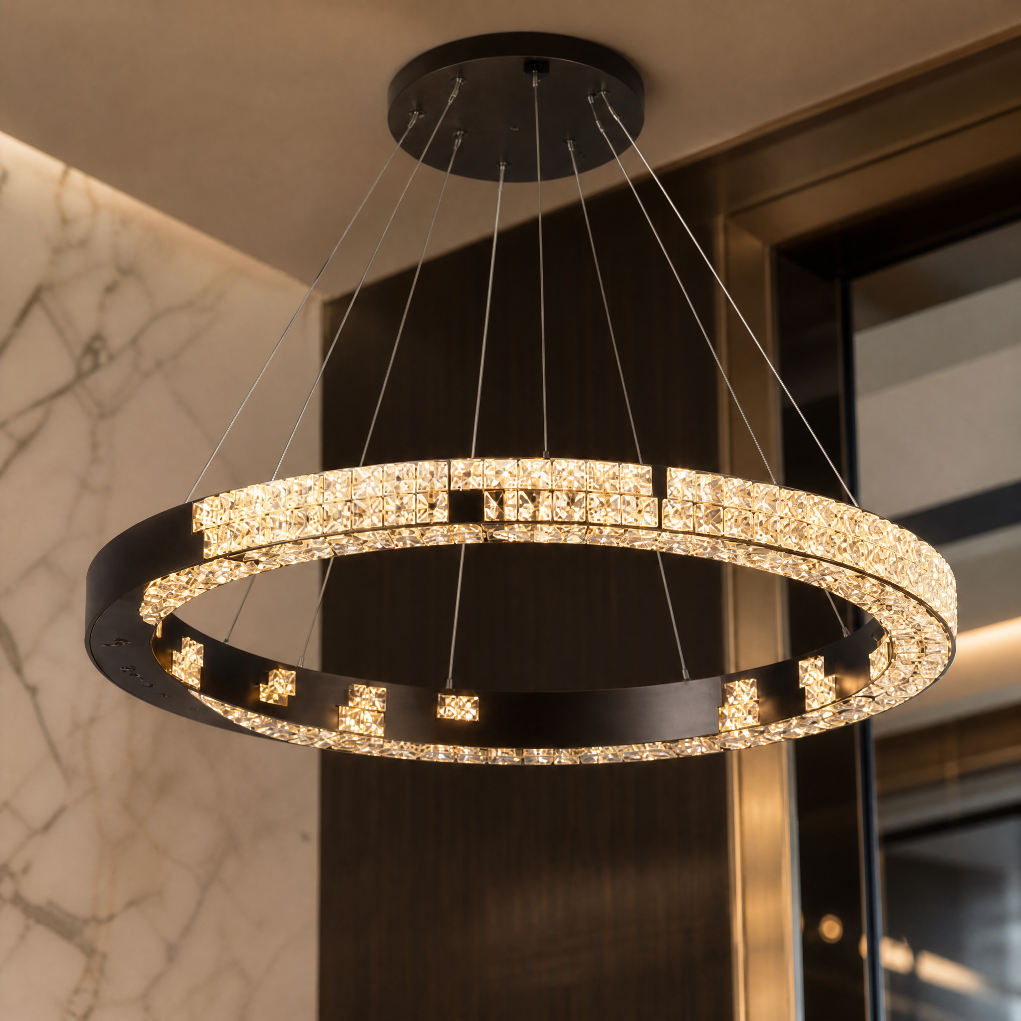 A detailed closeup of the Vorelli Minato Circular Chandelier highlighting the exquisite textures of its radiant crystal bars and contemporary design.