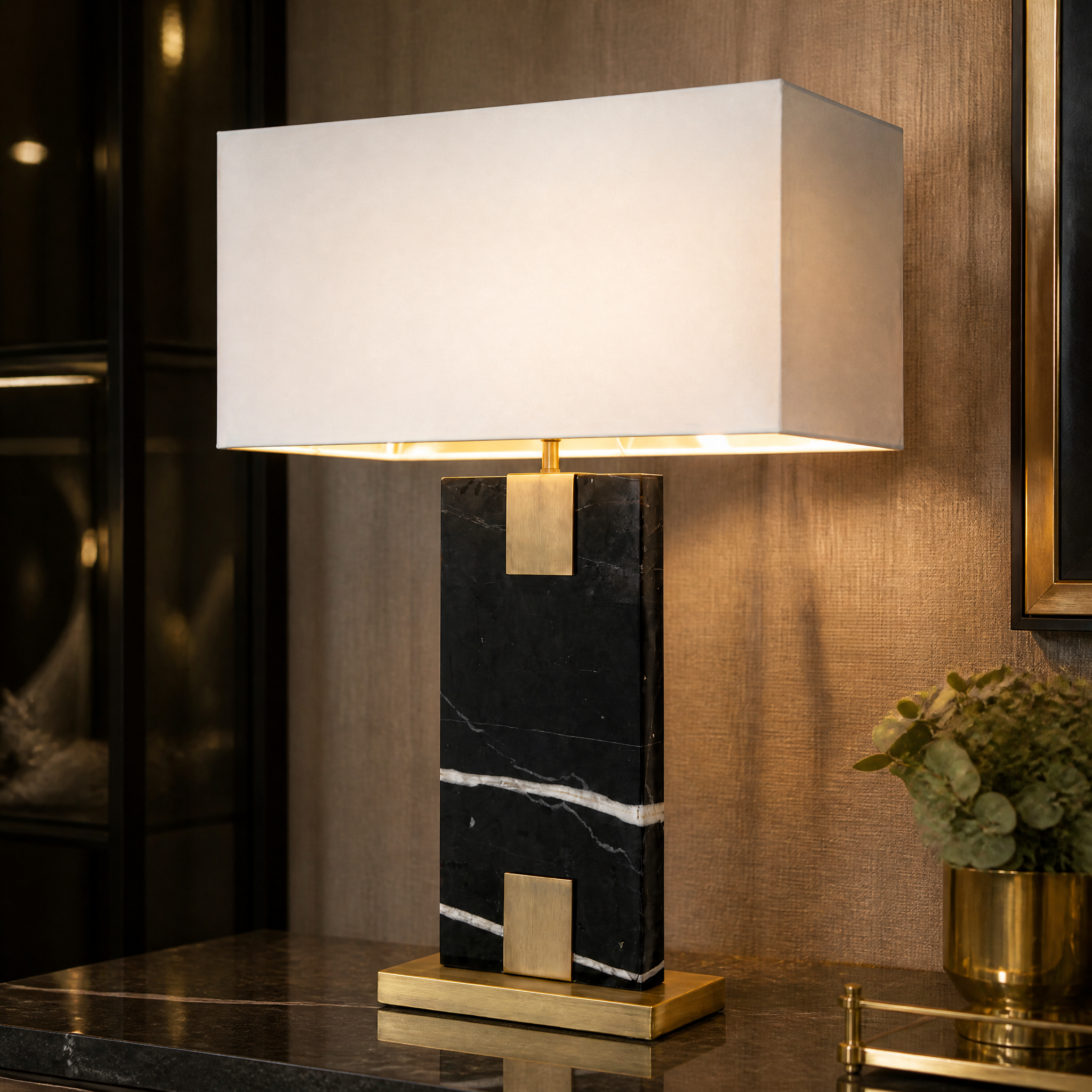 Close-up detail of the VORELLI Navaro table lamp showing the rich texture of the solid black marble base and refined antique brass detailing.