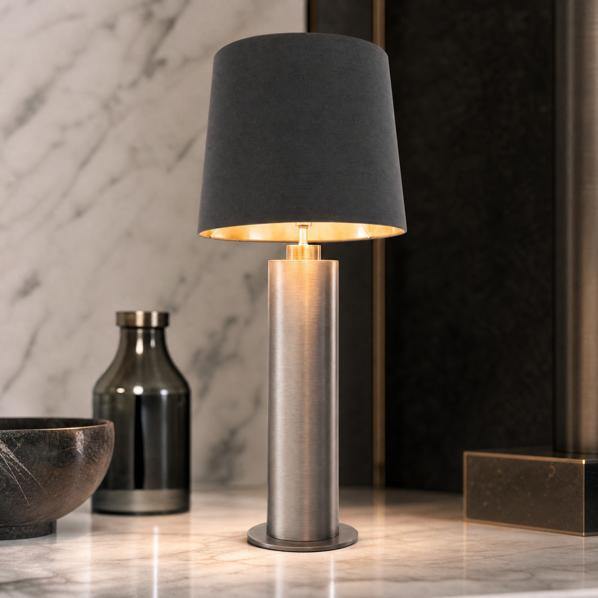 Macro closeup of the VORELLI Norvane table lamp, highlighting the textured brushed gunmetal finish on its clean cylindrical base.