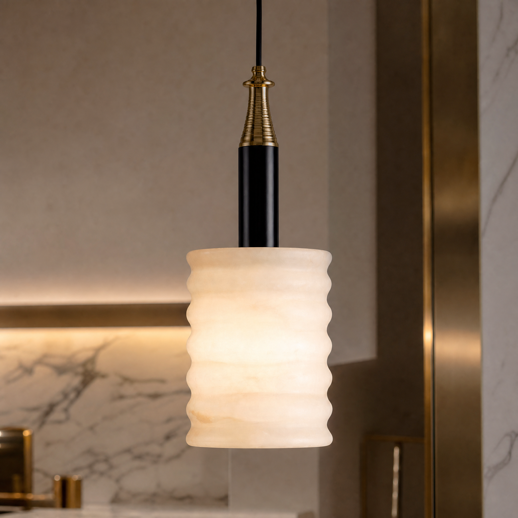 Close-up detail of the VORELLI Noto pendant light, showcasing the fluted marble shade and the playful black and gold sculptural fitting.