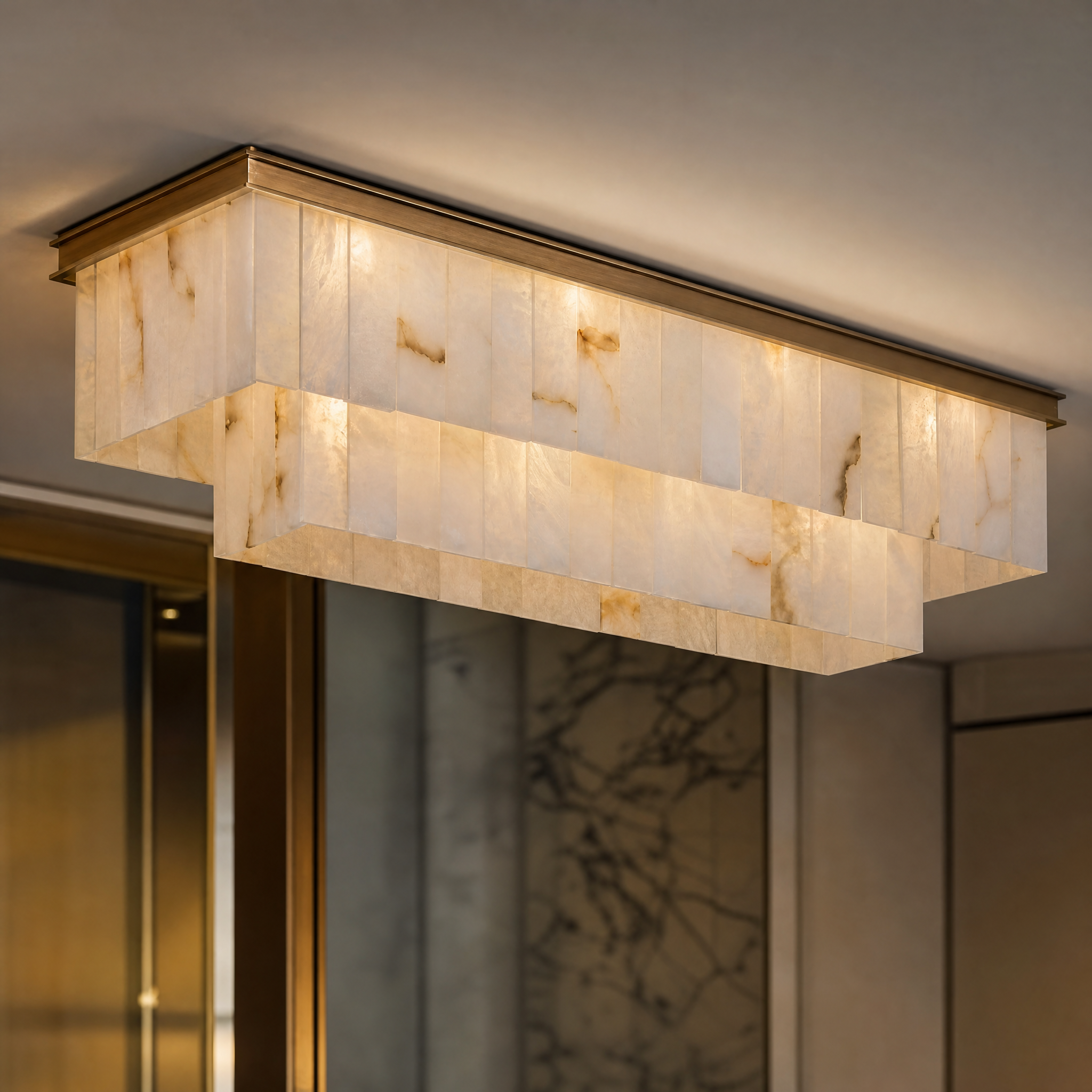 A detailed closeup of the VORELLI Novella Marble Rectangular Chandelier, highlighting the softly layered marble panels and quiet elegance of the craftsmanship.