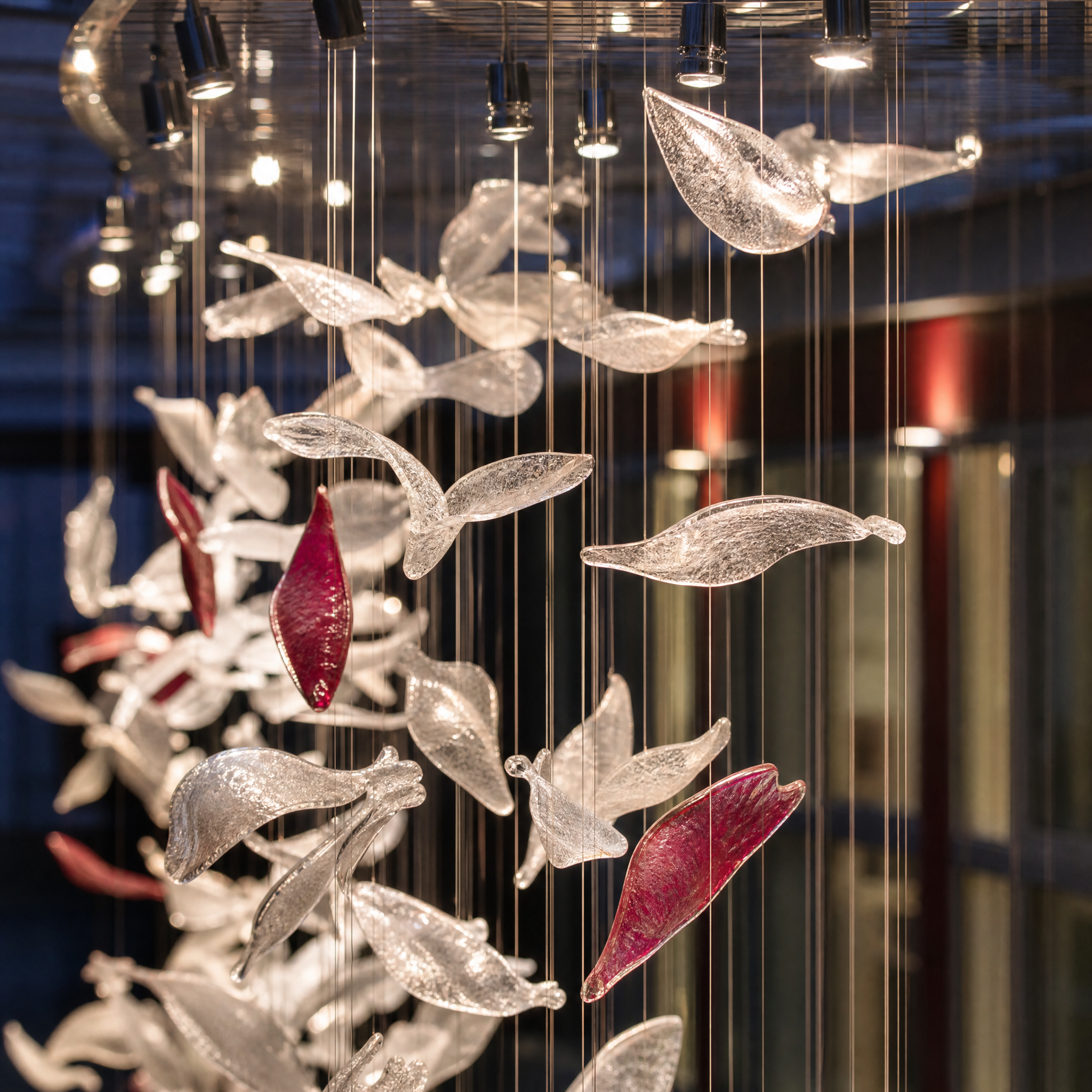 Close-up detail of the VORELLI Petal Cascade installation, showcasing the exquisite craftsmanship of individual delicate glass petals capturing and refracting light.