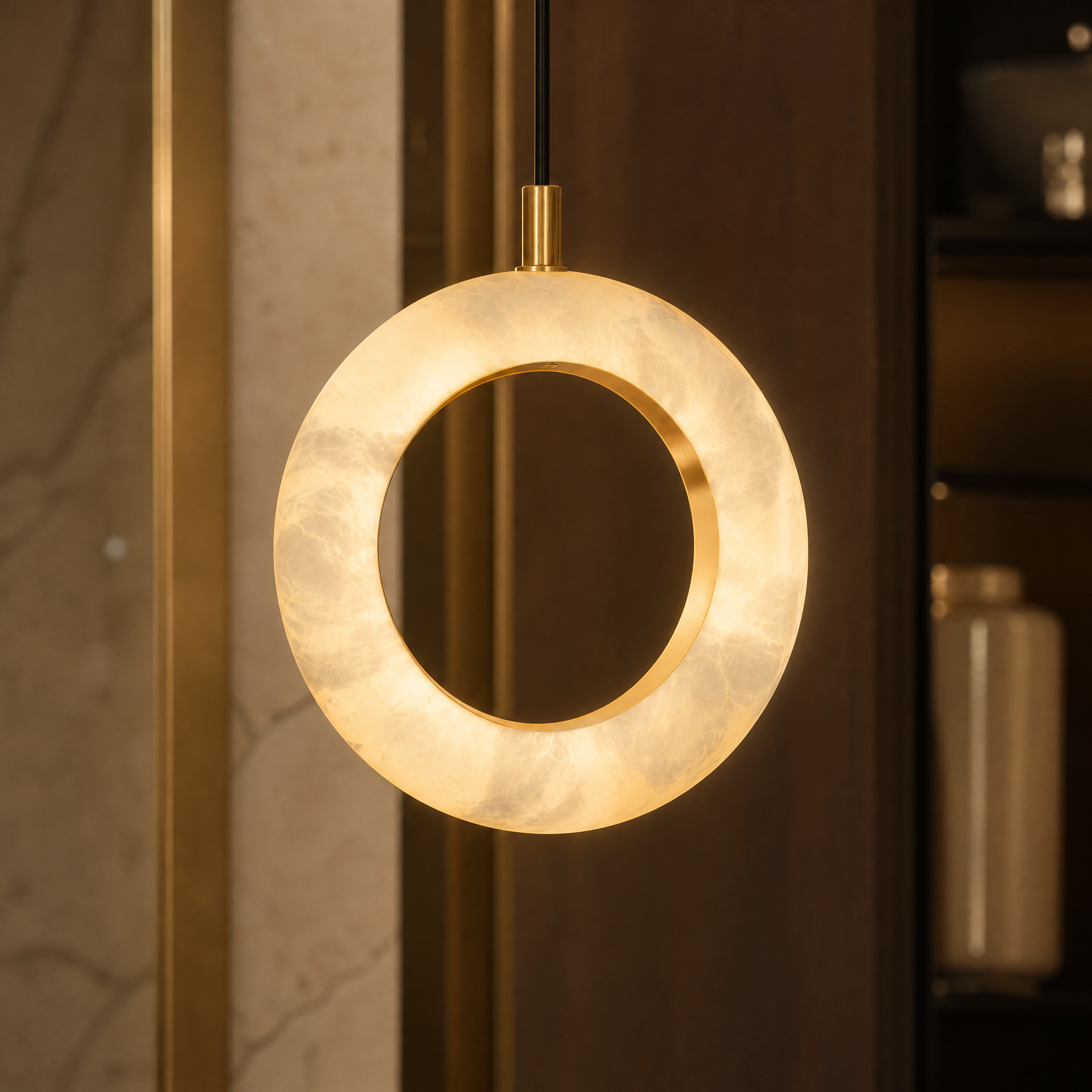 A detailed closeup of the VORELLI Pietra Marble Pendant Light showing the unique natural veining and warm translucency of the glowing marble ring.