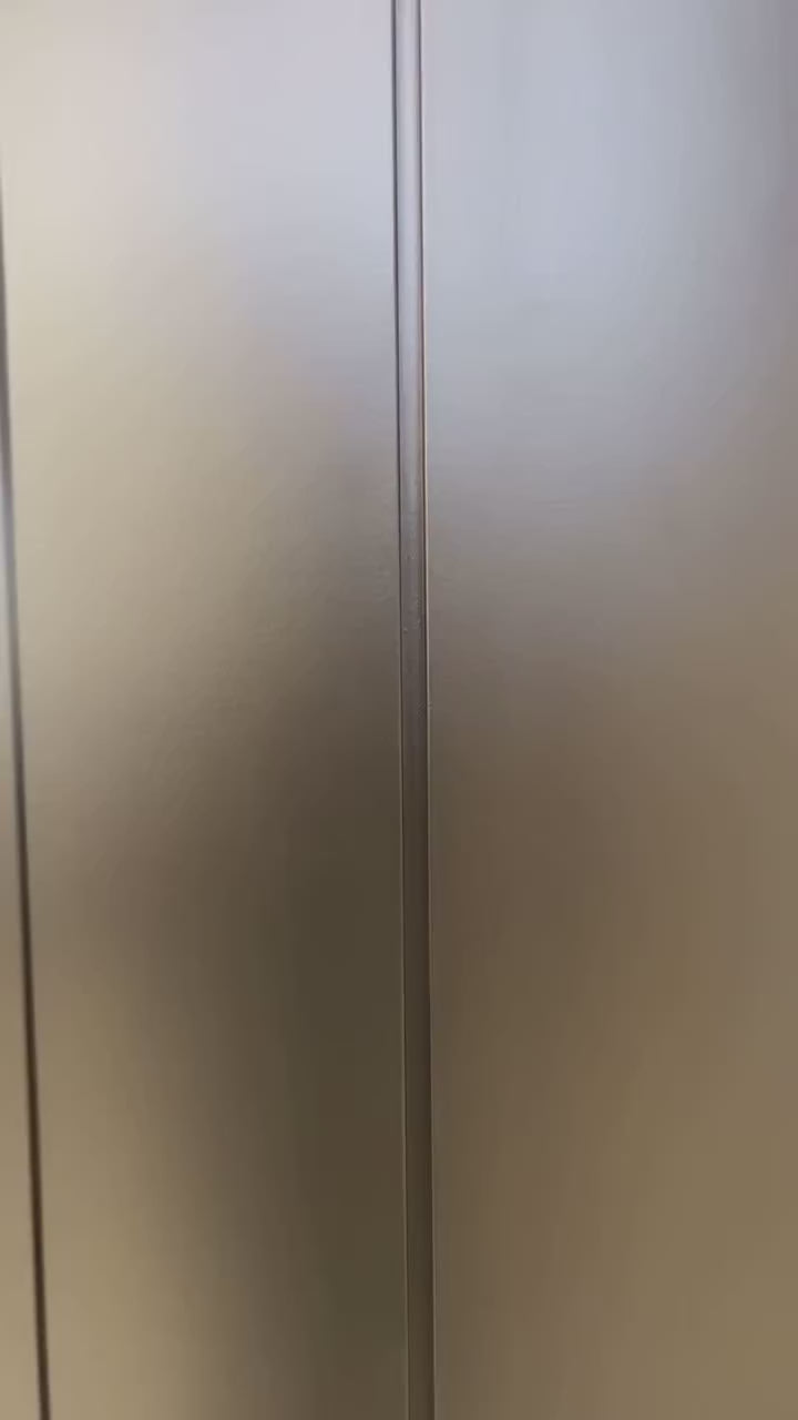 VORELLI Belair wall light illuminating a luxury hallway, creating warm ambient lighting and architectural elegance