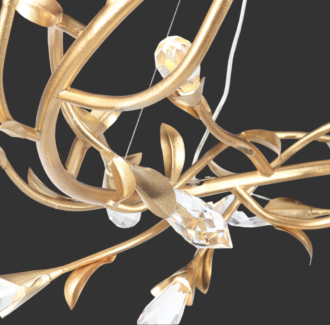 Close-up of sculptural gold branch chandelier with faceted crystal detailing