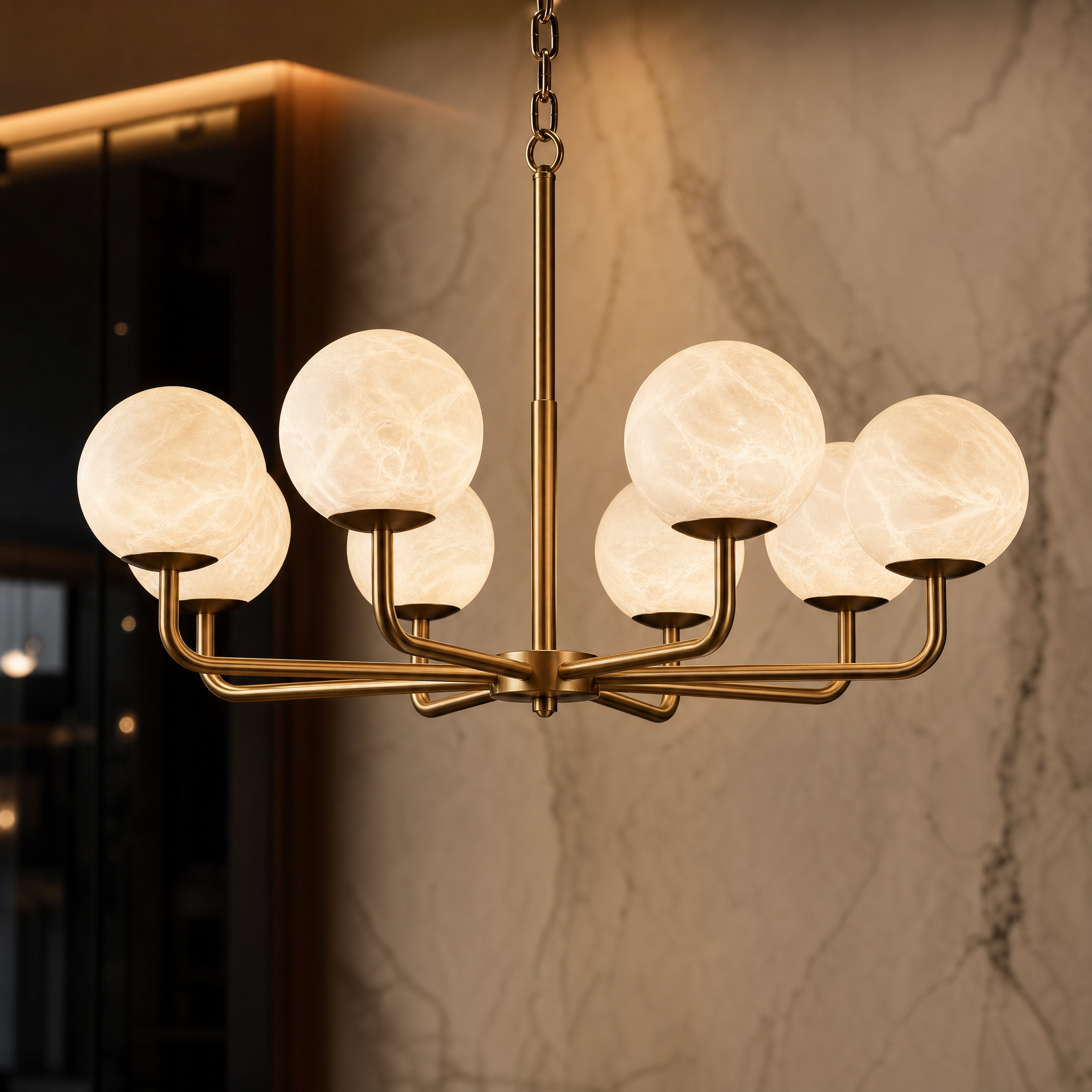 A detailed closeup of the VORELLI Ricco circular chandelier, highlighting the handcrafted luminous alabaster globe lights and the premium solid brass frame.
