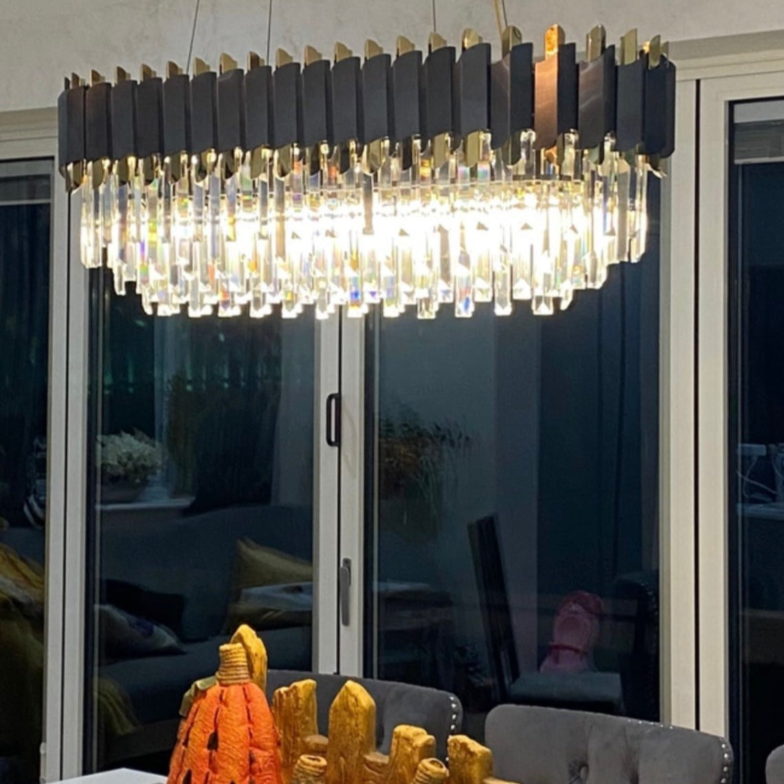 Richmond modern classic rectangular crystal chandelier installed above dining table in refined interior