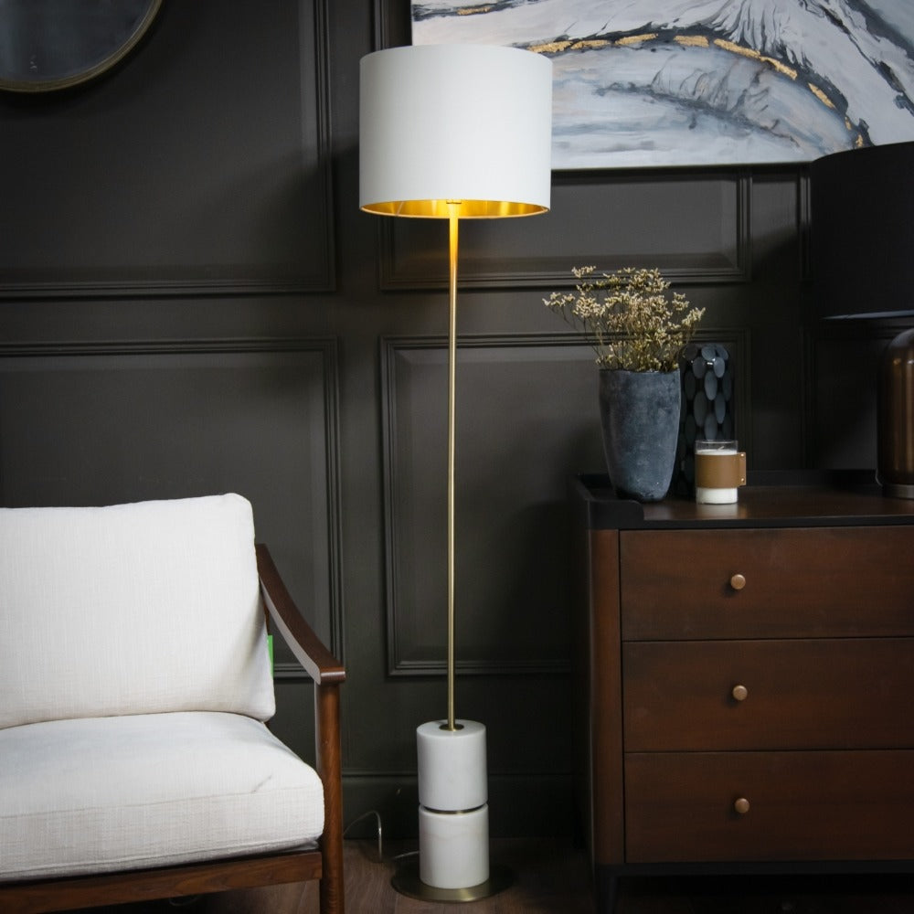 Robyn marble floor lamp featuring round stone base and slender vertical stem with fabric shade installed in refined interior