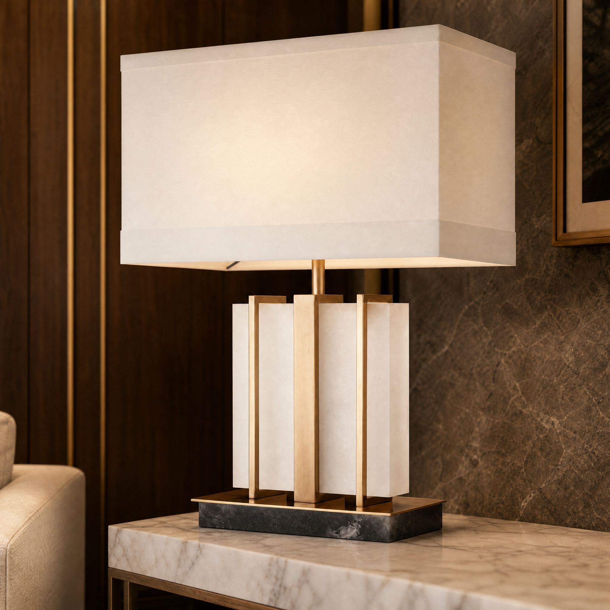 A detailed close-up shot of the Seravia Table Lamp showcasing the sculptural white alabaster base framed with premium antique brass accents and a tailored fabric shade.