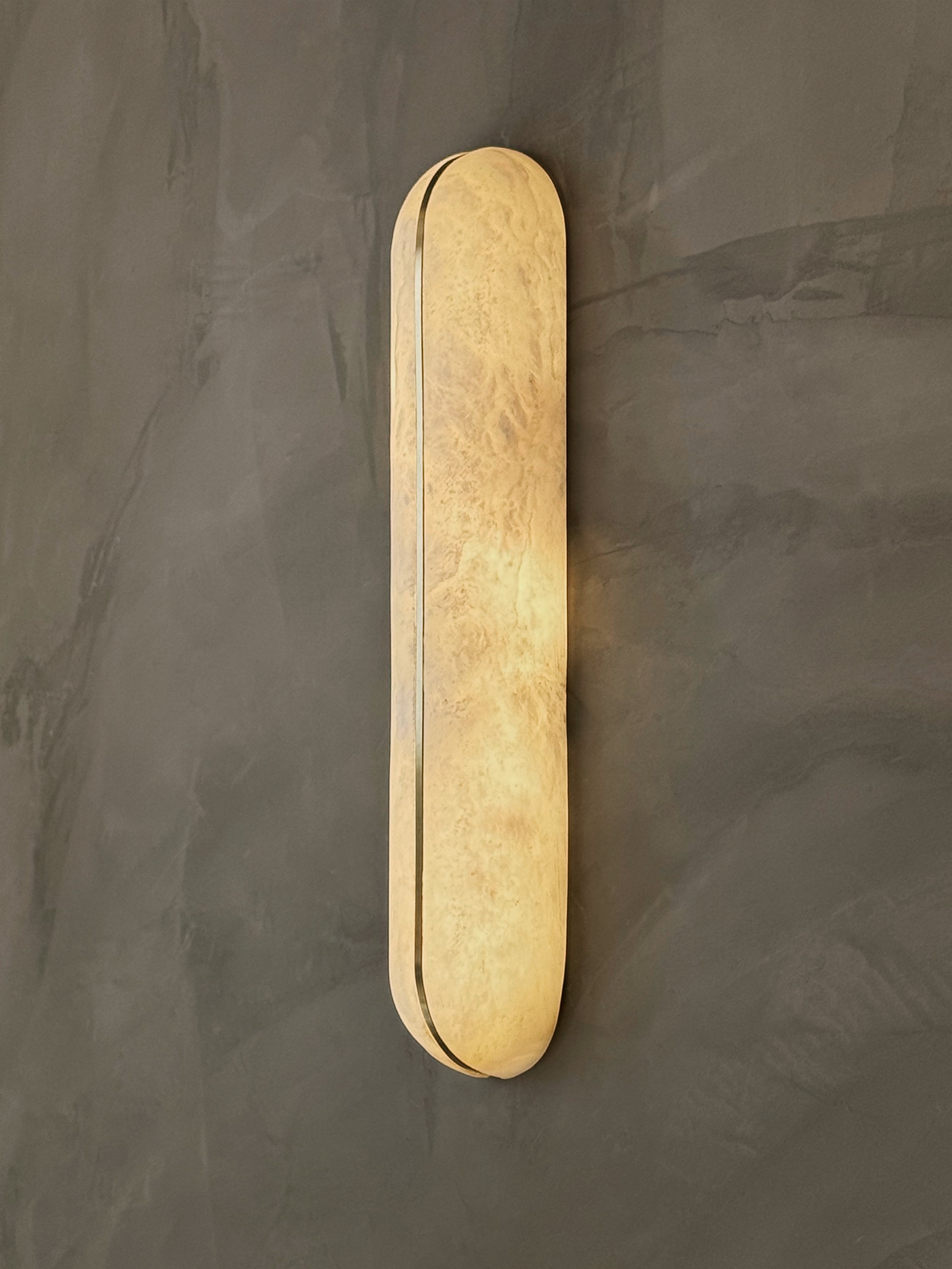 Serino luxury elongated marble wall lamp showcasing slim vertical stone form and minimalist detailing